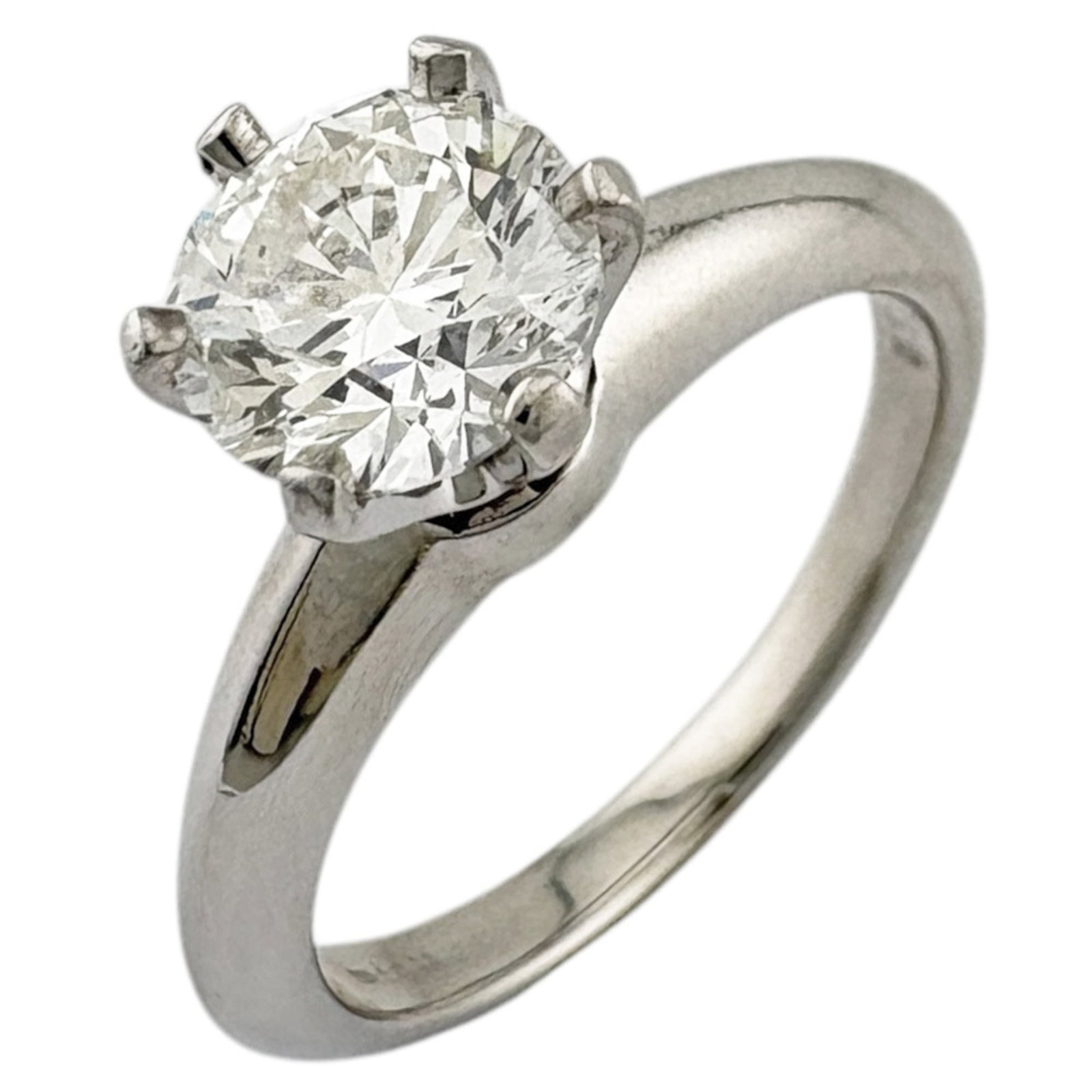 Platinum ring by Tiffany band: Platinum ring by Tiffany band Platinum ring by Tiffany features a silver band with a 1.04 carat diamond, showcasing excellent clarity and color grade. The ring bears the signature of its maker and is 