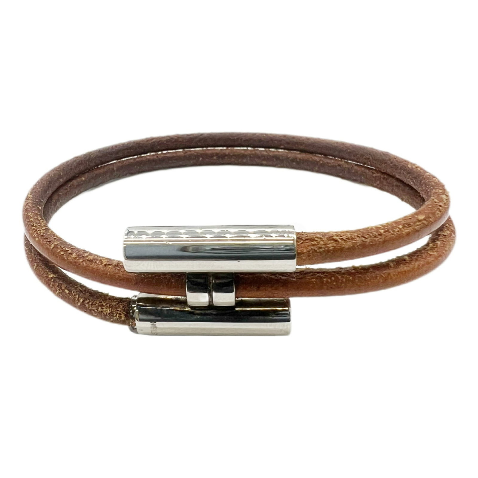 Metal Leather Charm Hermes Bracelet: Metal Leather Charm Hermes Bracelet This charming Hermes leather bracelet features a metal charm, with a rich brown and silver finish. The classic design showcases the signature style of the iconic