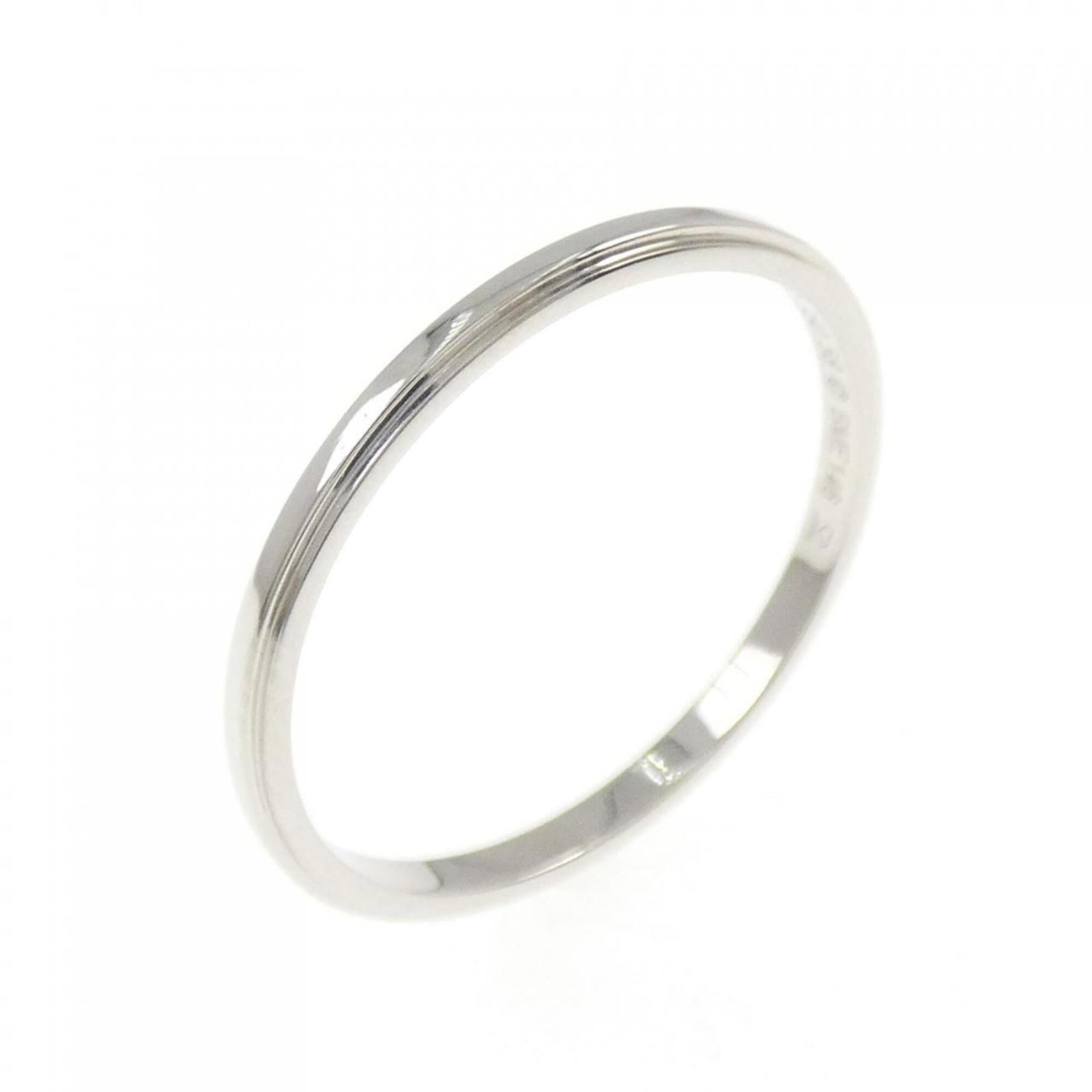 Ring Band by Platinum 950: Ring Band by Platinum 950 Platinum 950 band ring by Cartier, featuring a durable and luxurious material. The ring bears a few traces of usage, with some minor scratches and dirt visible, but remains