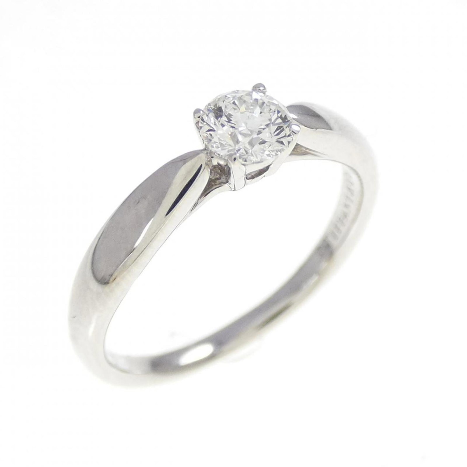 Platinum ring by Tiffany band: Platinum ring by Tiffany band Platinum ring by Tiffany features a diamond stone set in a band design. The item is made from platinum and has a us size of 4, with some minor scratches and dirt visible 