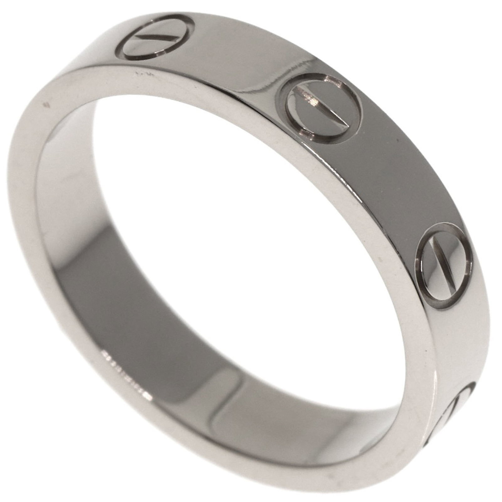 White Gold Cartier Band Ring 18K: White Gold Cartier Band Ring 18K This 18K white gold Cartier band ring features a classic design with a few traces of usage, some scratches and dirt visible. Despite its used condition, the ring