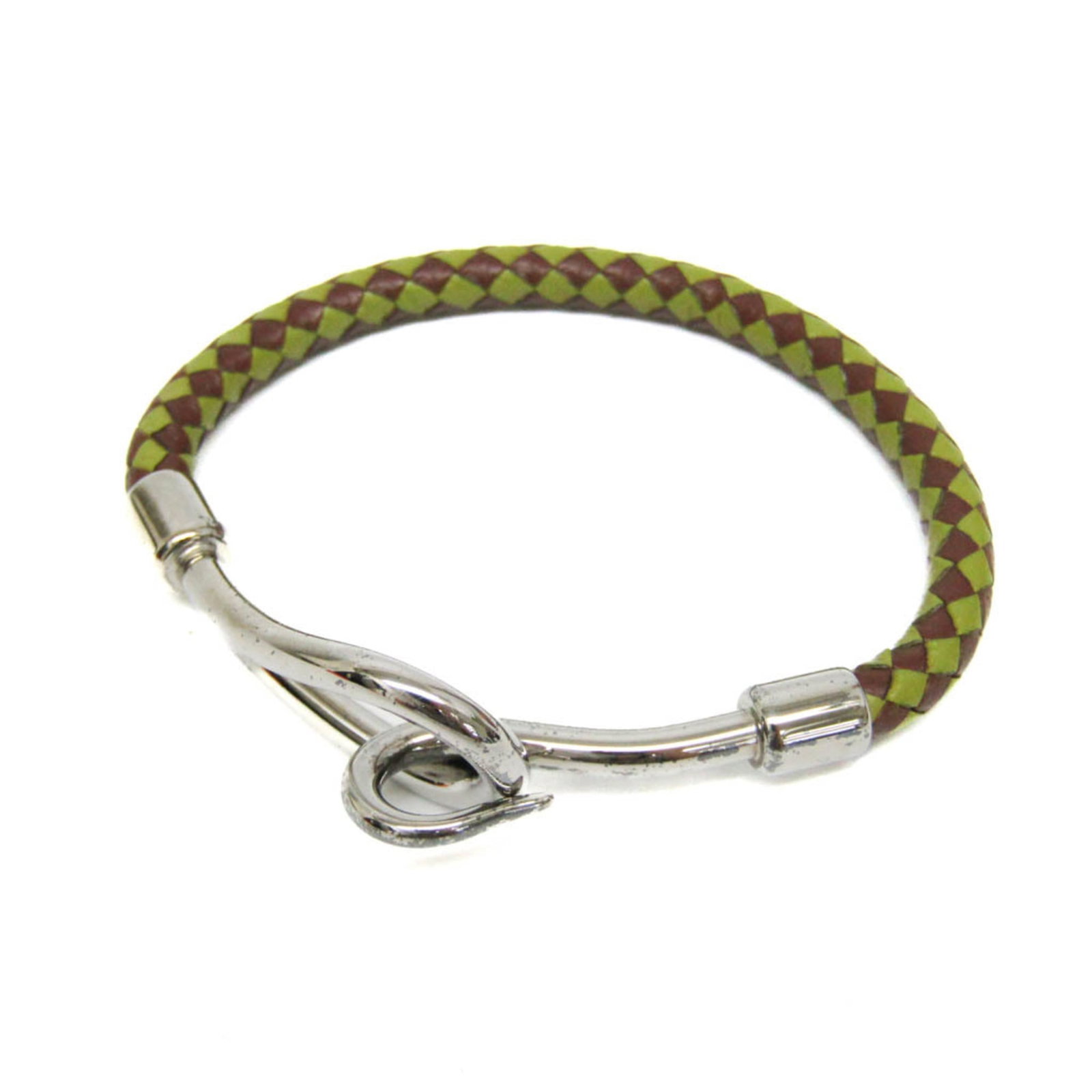 Metal leather bangle Hermes: Metal leather bangle Hermes Metal leather bangle from Hermes features dark brown, green, and silver tones. The bangle's leather and metal construction provides a sleek, fashion-forward design with