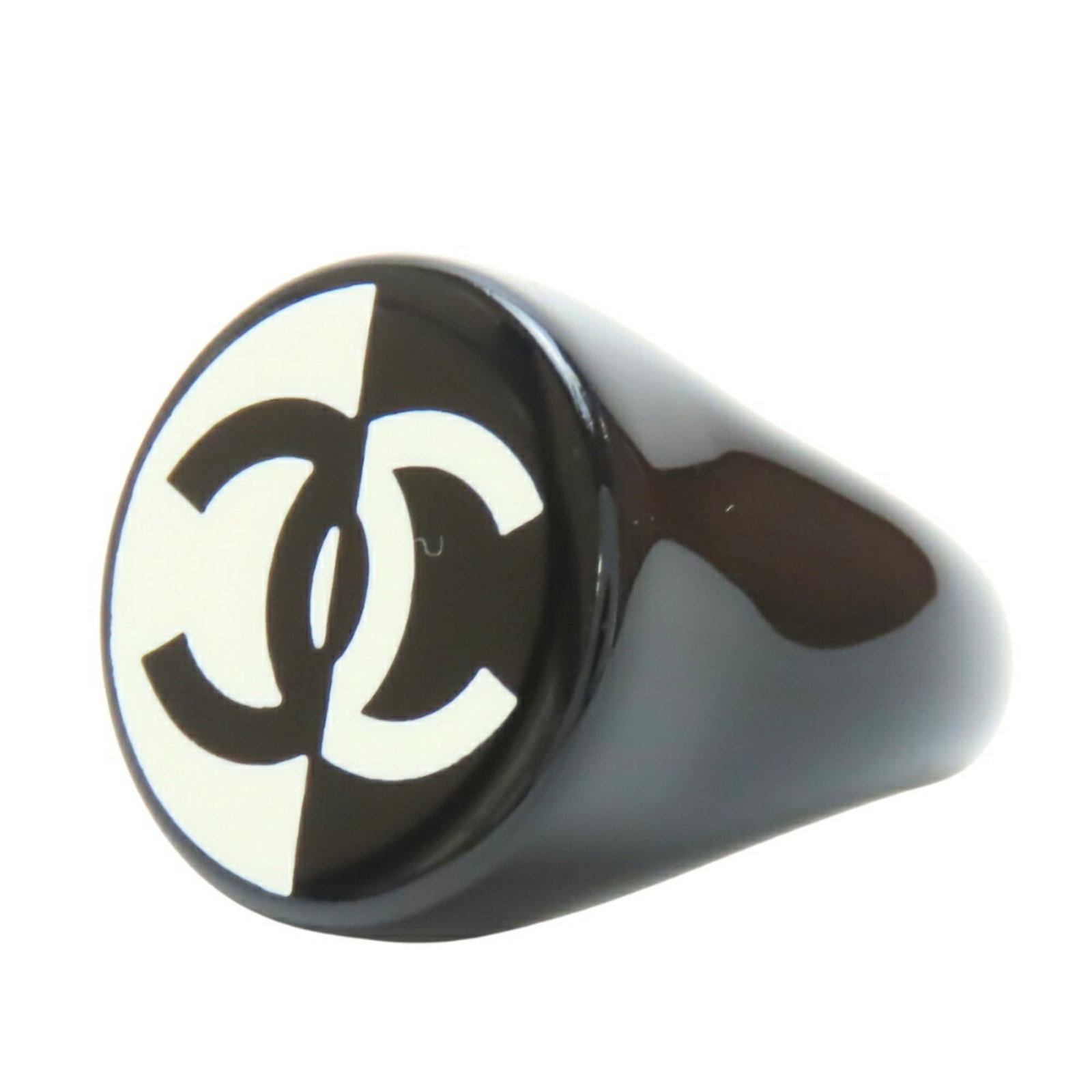 Ring Plastic Chanel Band: Ring Plastic Chanel Band This black and white plastic Chanel band ring features a sleek, modern design. Made from durable plastic, it boasts a lightweight construction weighing only 4.7g. In very good
