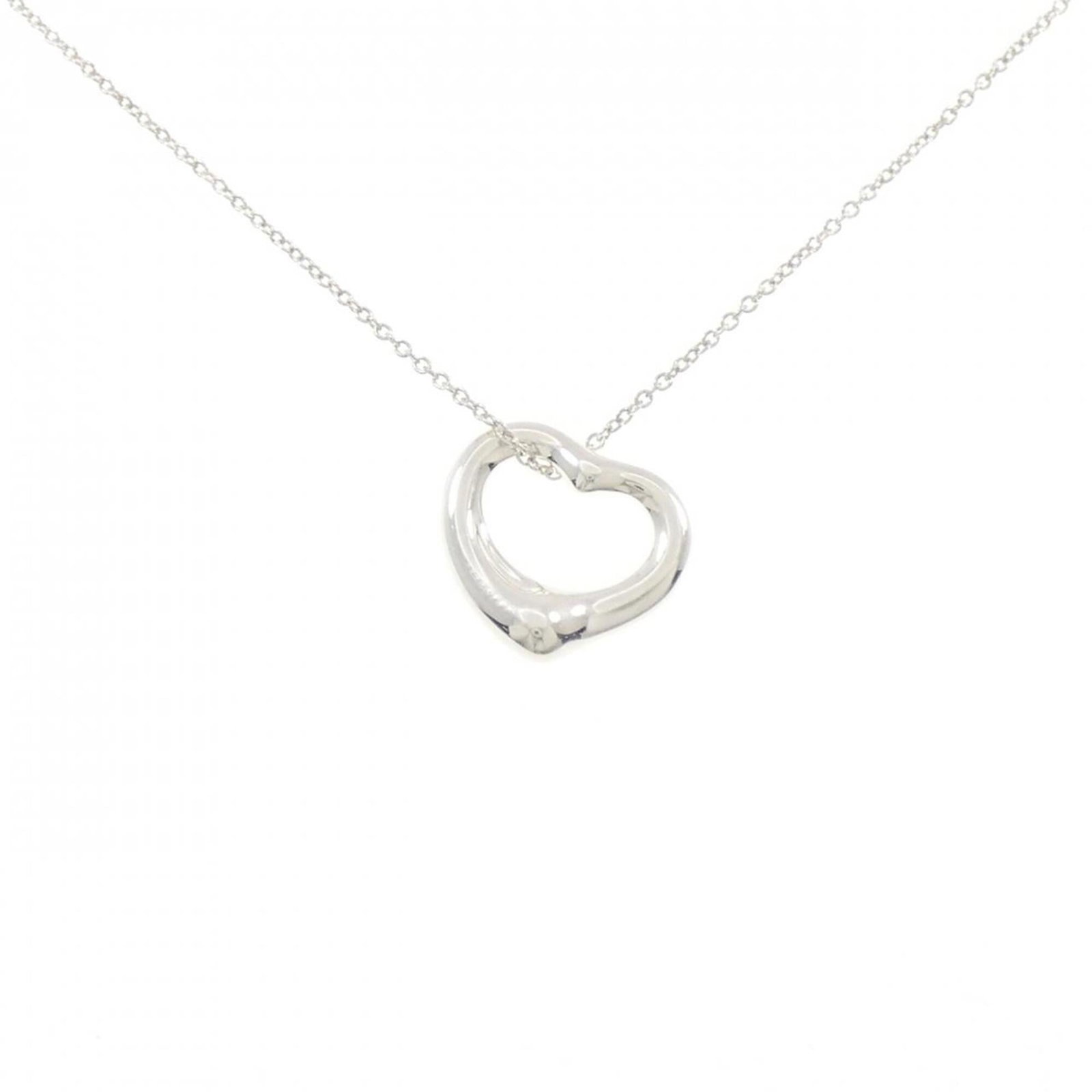 Heart Open Tiffany Necklace: Heart Open Tiffany Necklace Tiffany & Co. sterling silver necklace features a heart-shaped pendant, showcasing the brand's iconic style. The necklace boasts a classic design with a 40 cm chain circumf