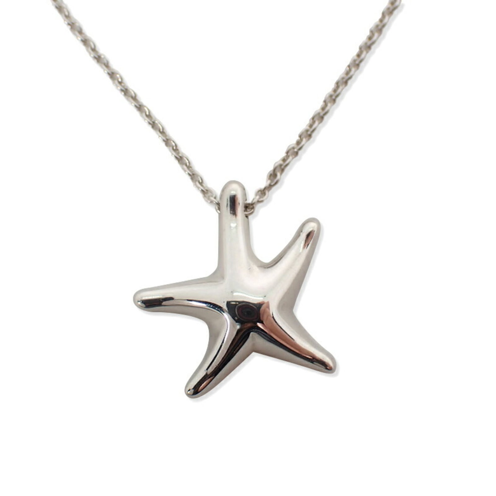 Starfish Pendant by Tiffany Co.: Starfish Pendant by Tiffany Co. Sterling silver pendant with intricate design, crafted by Tiffany Co. Features a starfish motif, measuring 15.3mm x 14.8mm, suspended from a chain with a 42 cm /