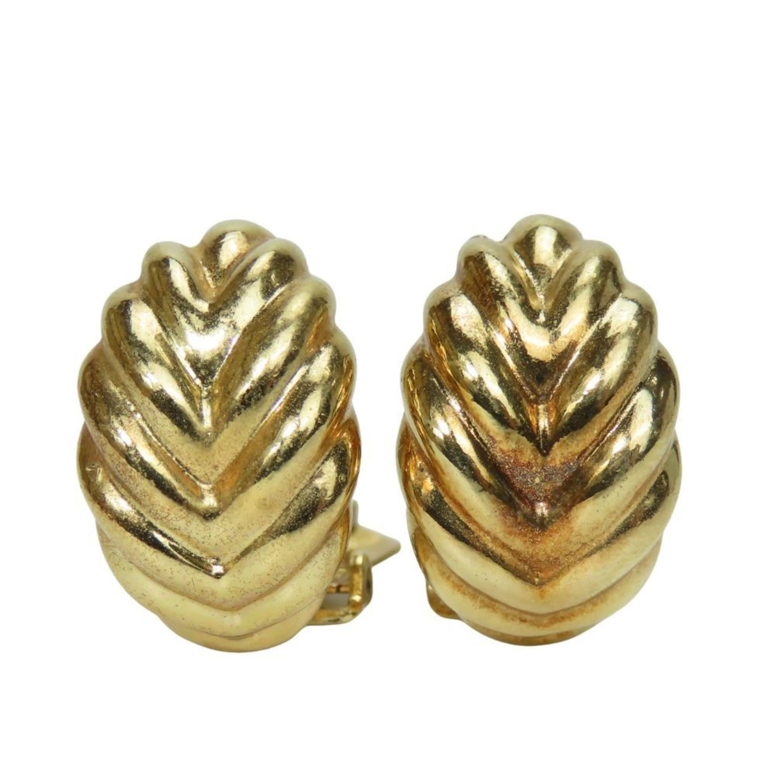 Metal clip earrings by Christian Dior: Metal clip earrings by Christian Dior Metal clip earrings by Christian Dior, featuring a gold metal design with traces of usage and minor scratches. The earrings are made from high-quality metal and