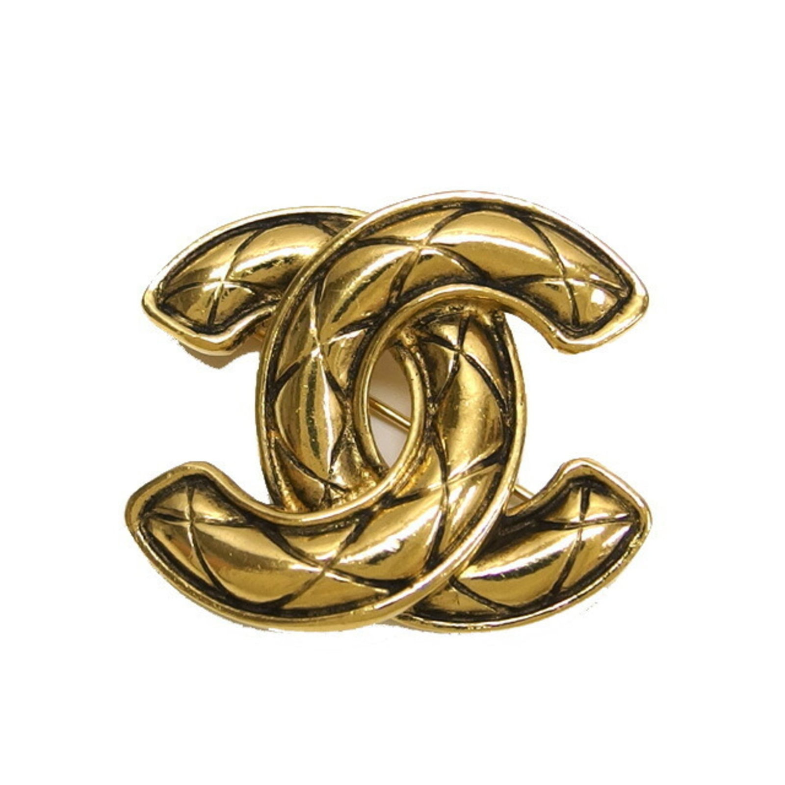 Metal brooch by Chanel: Metal brooch by Chanel This gold metal brooch by Chanel features a diamond stone, showcasing the luxury and elegance of the iconic fashion brand. With its vintage charm and subtle signs of wear, this 