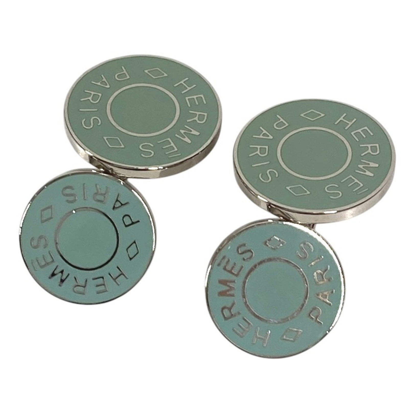 Metal cufflinks by Hermes: Metal cufflinks by Hermes Metal cufflinks by Hermes, bearing traces of usage and minor scratches, are available in blue and silver finishes. Made from metal, these cufflinks showcase a classic design 