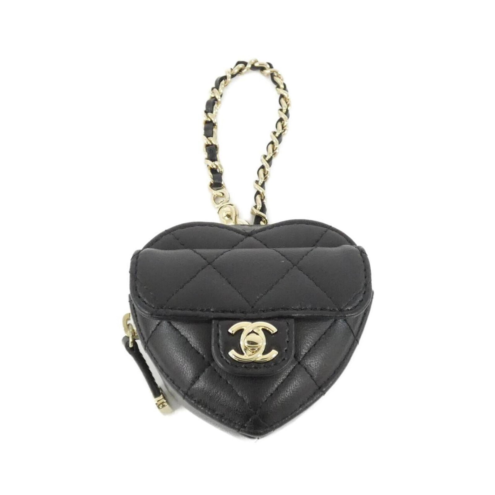 Chanel Handbag Charm Leather: Chanel Handbag Charm Leather This black leather Chanel handbag charm features lamb leather and measures 75.00mm x 80.00mm, with a few traces of usage visible due to scratches and dirt. The charm is in