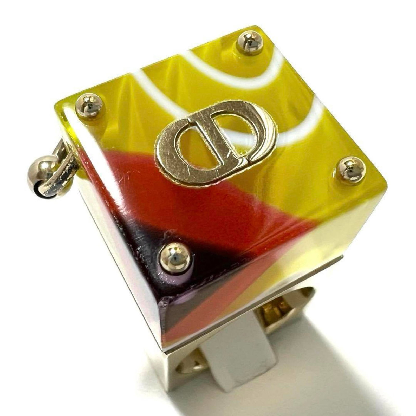 Metal Plastic Dior Christian Band Ring: Metal Plastic Dior Christian Band Ring Made from metal and plastic, the Dior Christian Band Ring boasts a sleek design. With some minor scratches and dirt, it remains in very good condition despite be