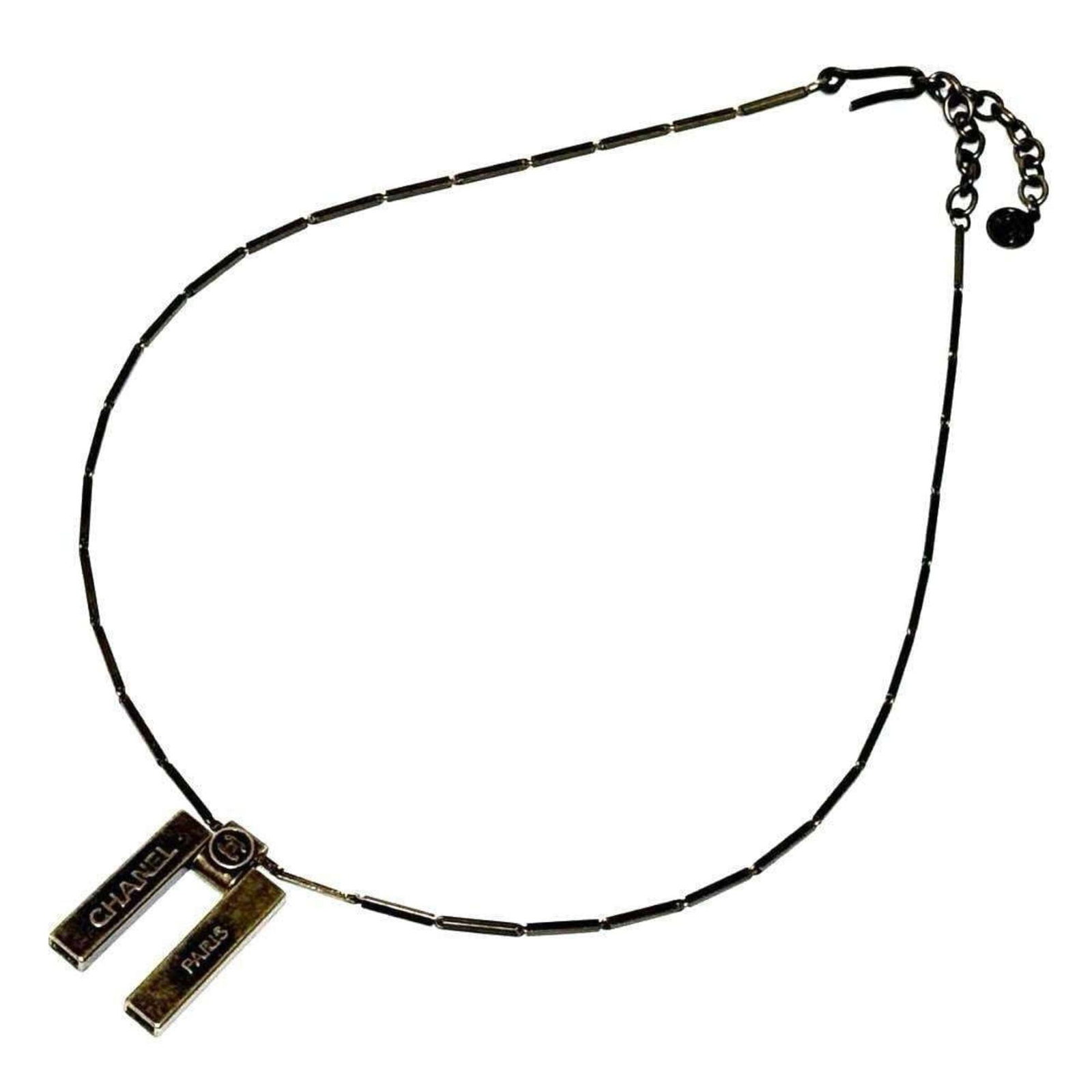 Women's Chanel Necklace Pendant: Women's Chanel Necklace Pendant Chanel's iconic necklace pendant, featuring the brand's signature style, is available for purchase. Made from metal and designed to fit necks with a circumference