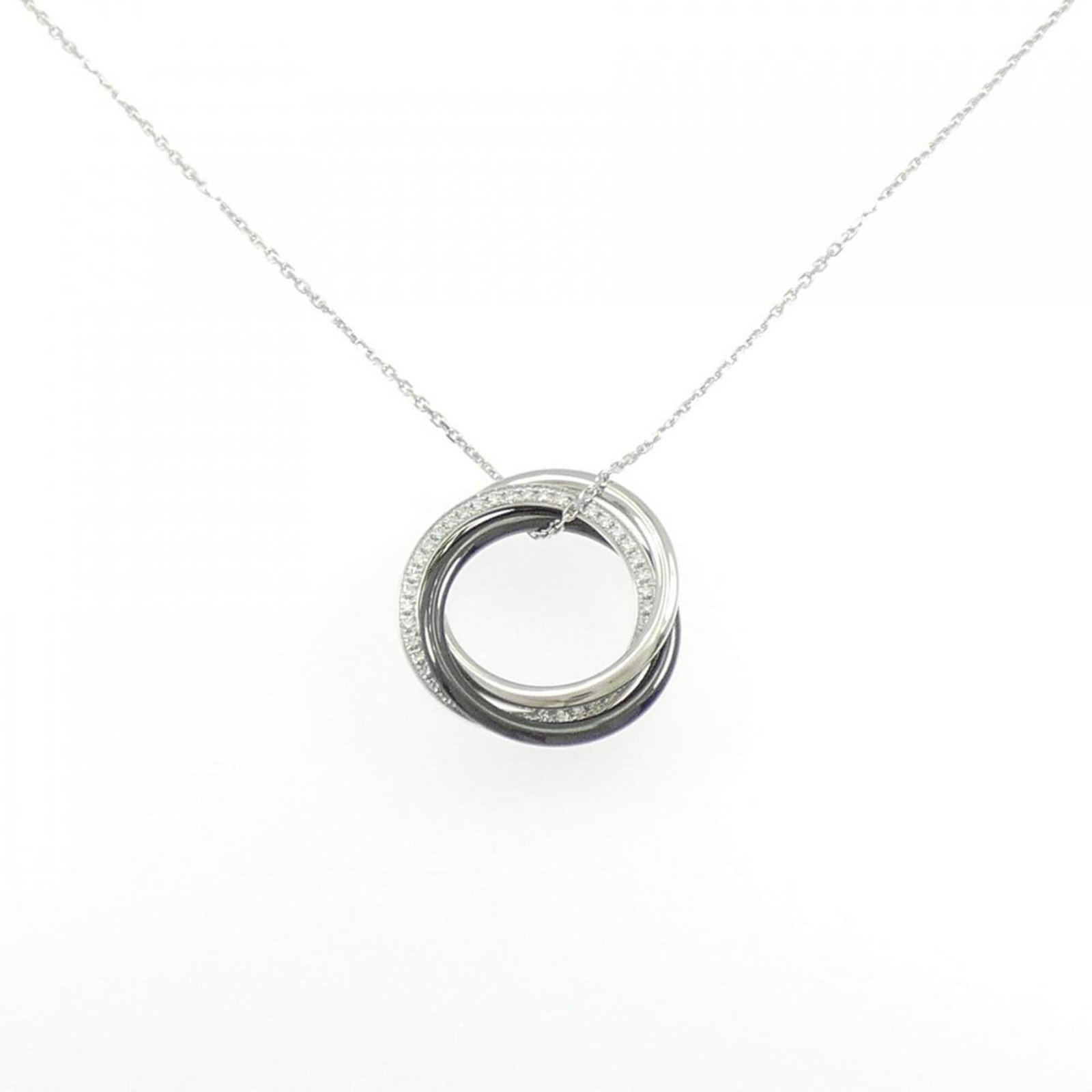 Black White Necklace Cartier Trinity: Black White Necklace Cartier Trinity Cartier's iconic Trinity necklace features a striking black and white design, with a ceramic and white gold (18K) pendant adorned by a diamond. The necklace boasts