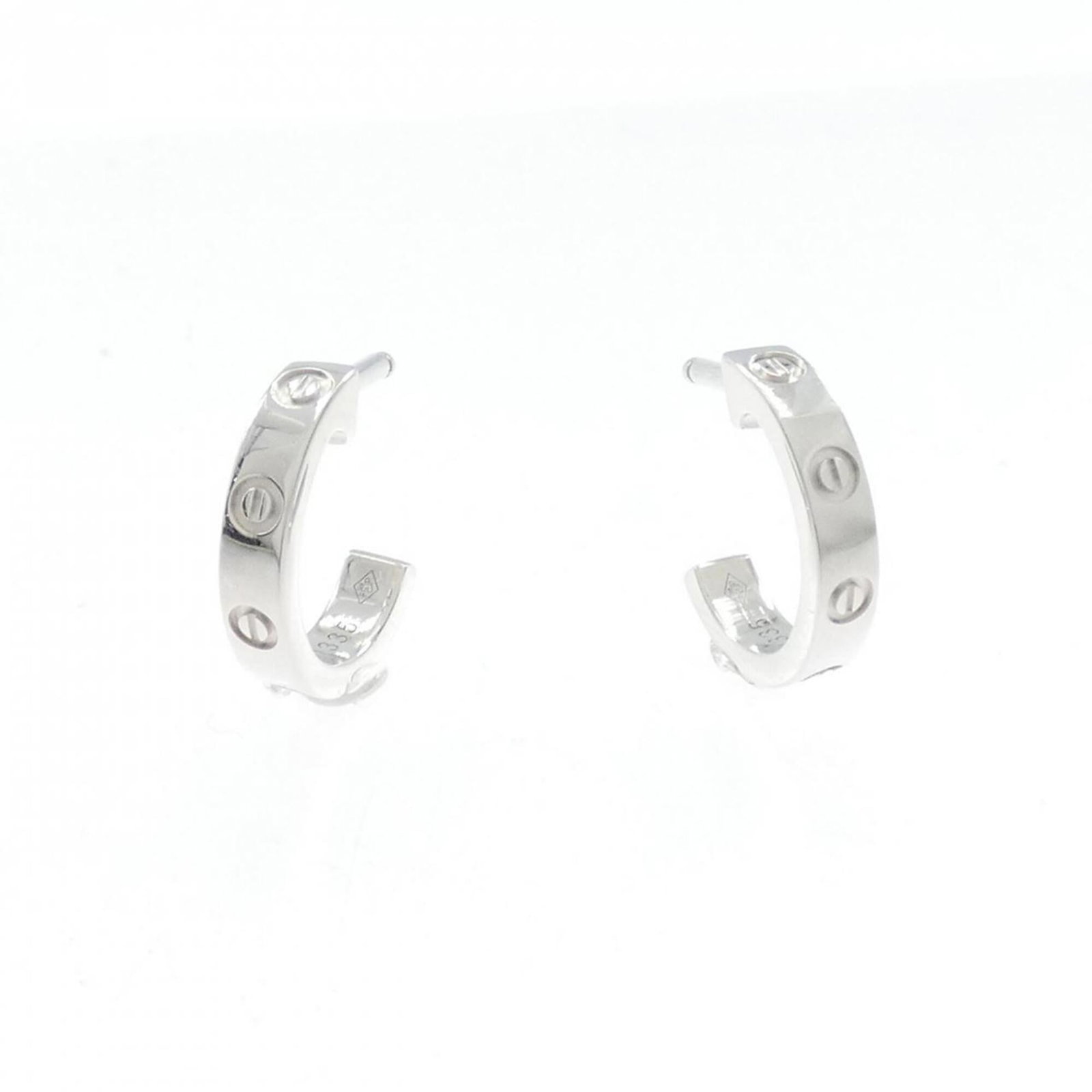 Love Cartier Mini Earrings: Love Cartier Mini Earrings Used Cartier Mini Earrings in White Gold feature a white stone, measuring 12.70mm x 2.60mm. The earrings have some traces of usage and minor scratches/dirt but are overall i