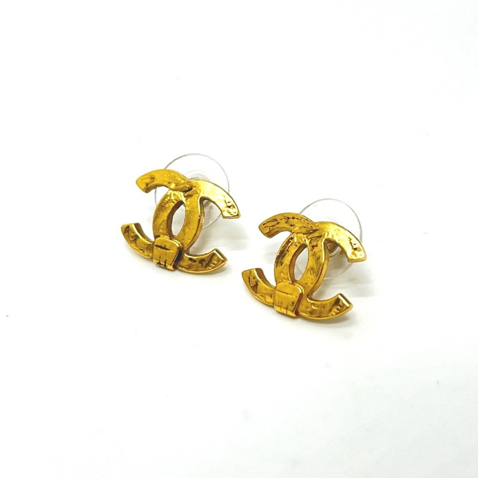 Stud Earrings Metal by Chanel: Stud Earrings Metal by Chanel Gold stud earrings by Chanel, featuring metal construction and a classic design. The item shows some signs of usage, including minor scratches and dirt, but remains in