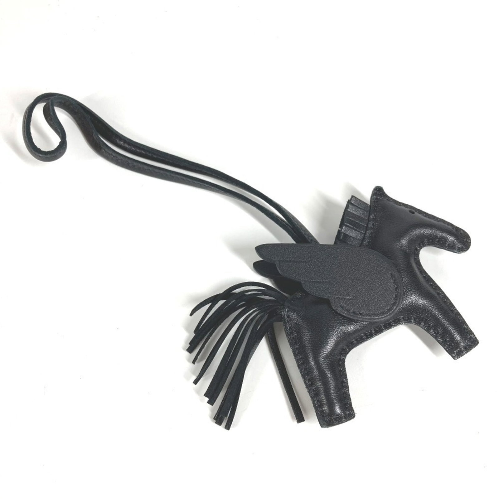 Hermes Handbag Charm Agneau Milo: Hermes Handbag Charm Agneau Milo Agneau Milo, the iconic material from Herm?s, gives this handbag charm its distinctive look and feel. With its black color and signs of gentle use, this charm