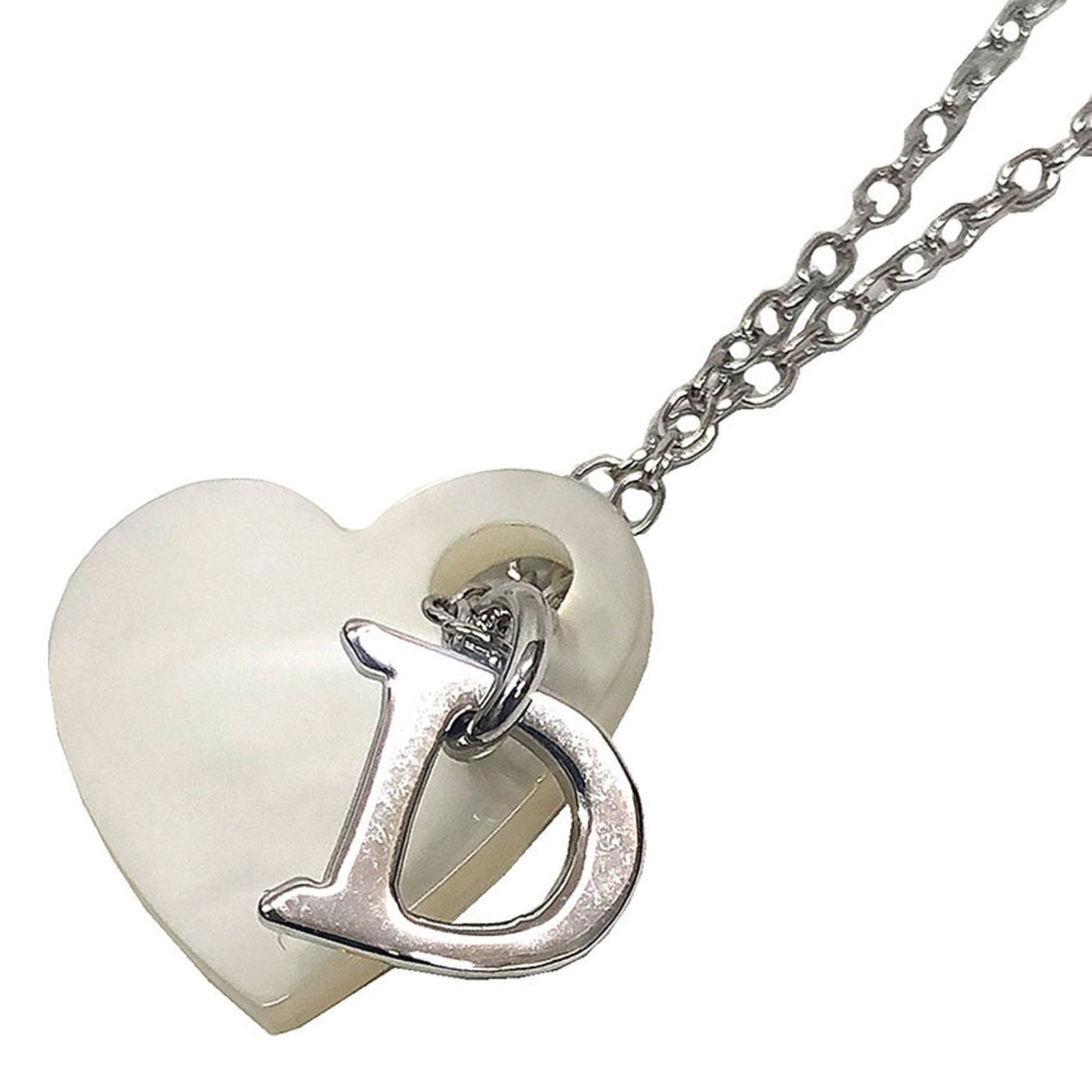 Christian Dior Heart Necklace: Christian Dior Heart Necklace The Christian Dior Heart Necklace boasts a sleek silver design with a delicate brass shell, making it a striking accessory for women. Measuring 1.8mm x 2mm in size, the p