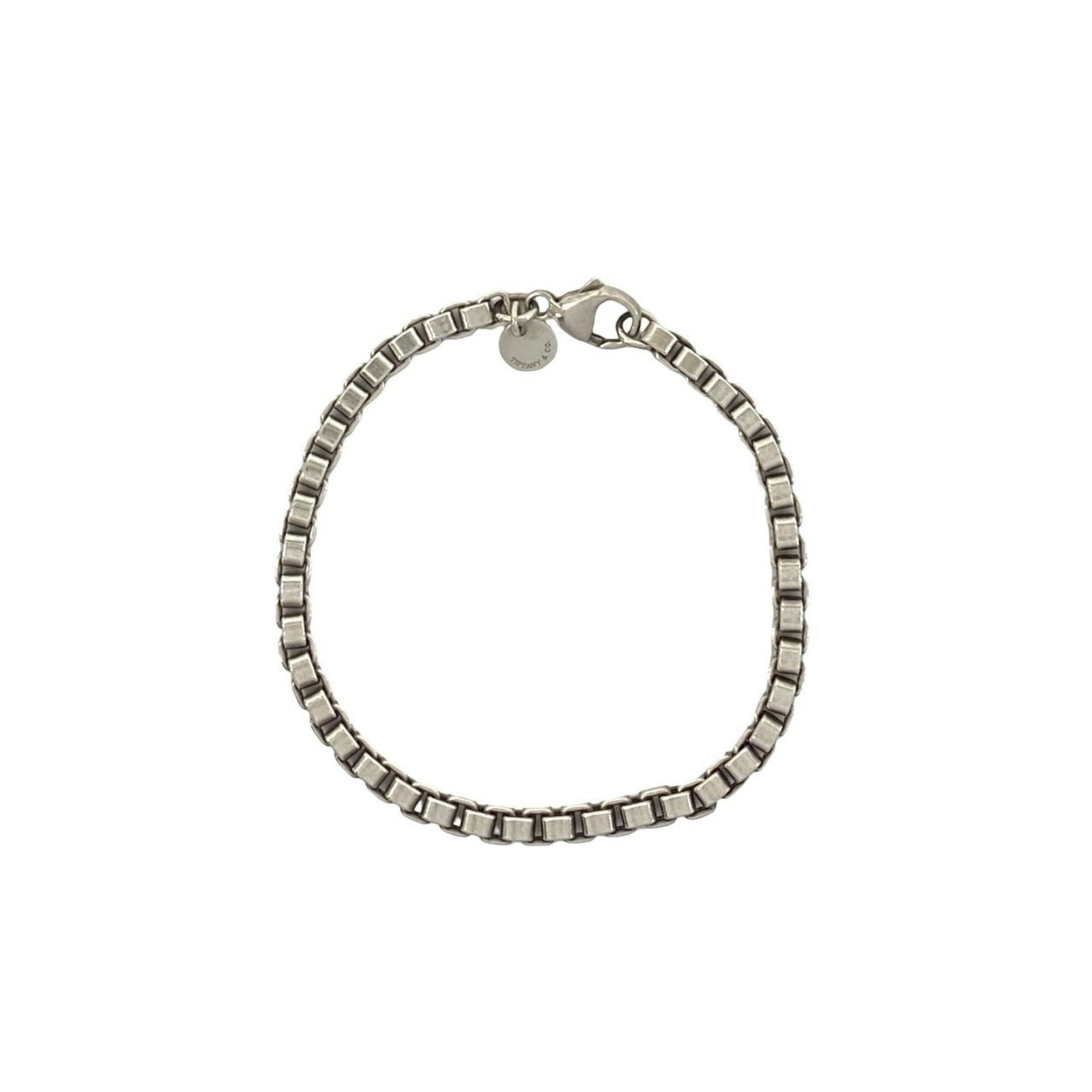 Charm Tiffany Bracelet 925 Silver: Charm Tiffany Bracelet 925 Silver Silver charm bracelet from Tiffany, made from 925 sterling silver with a length of 16.5cm. The bracelet bears traces of usage and minor scratches/dirt, but remains in