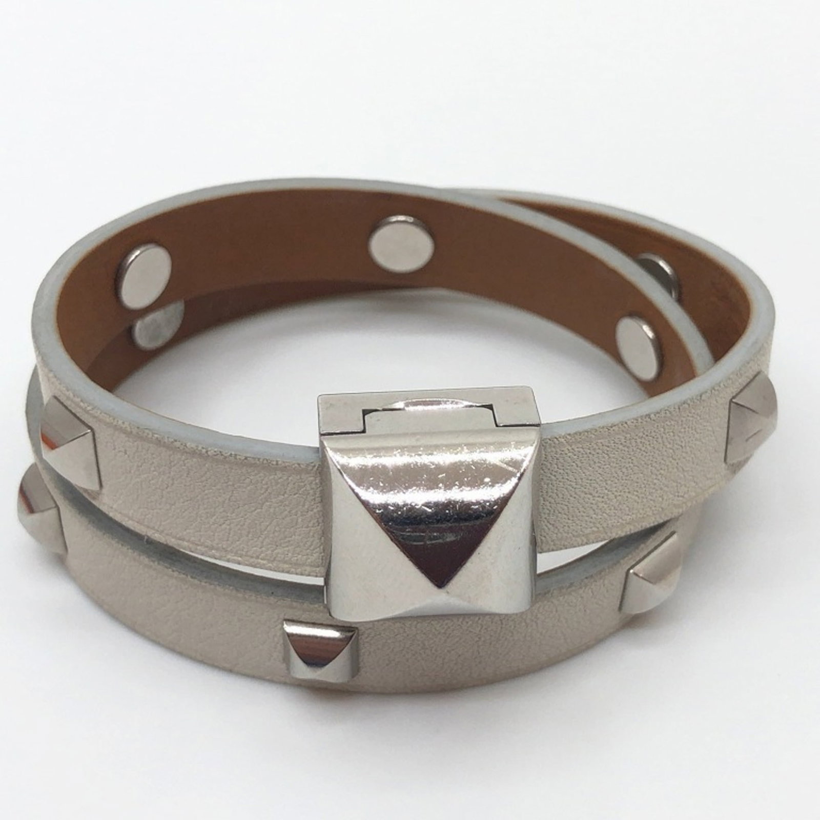 Charm Bracelet by Hermes: Charm Bracelet by Hermes Used Hermes Charm Bracelet, bearing traces of usage and minor damages. Still in acceptable condition for continued wear, the bracelet showcases its signature style with a mix 
