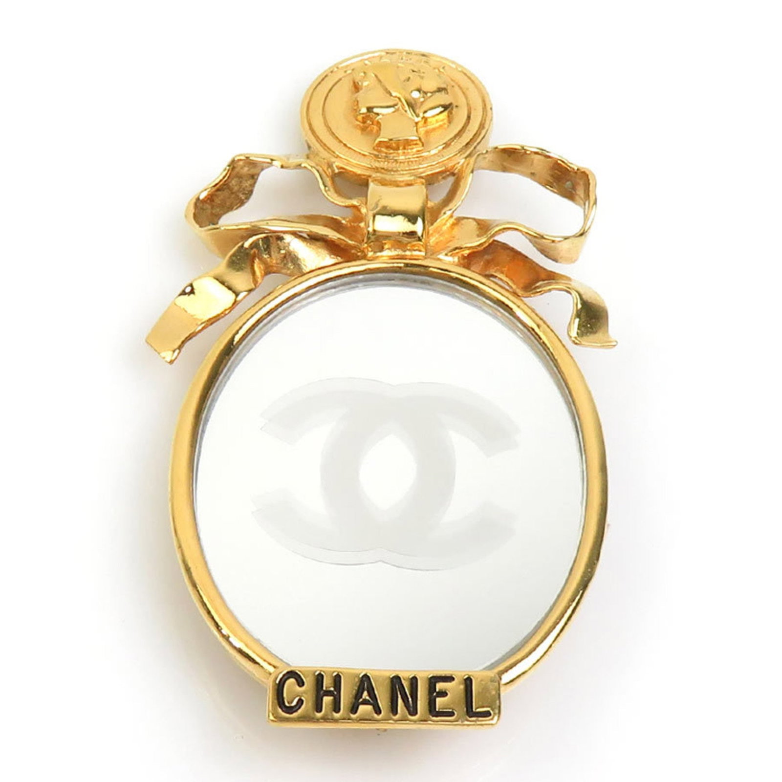 Metal brooch by Chanel: Metal brooch by Chanel A gold metal brooch by the renowned French fashion house Chanel, bearing traces of usage and minor scratches. The piece measures 9cm x 5cm in size, offering a subtle yet elegant