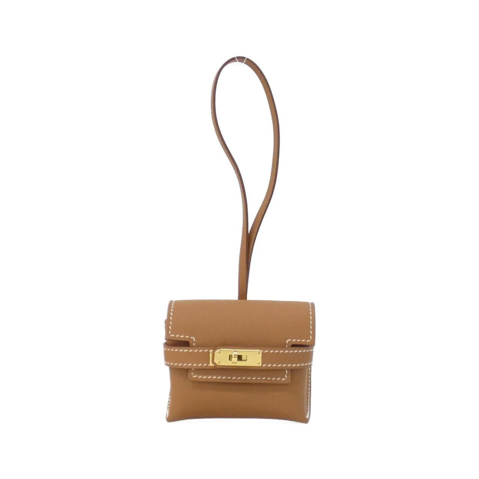 Swift leather handbag charm Hermes: Swift leather handbag charm Hermes Swift leather handbag charm from Hermes, featuring brown swift leather and a unique size. The charm bears some traces of usage, including scratches and dirt, but rem