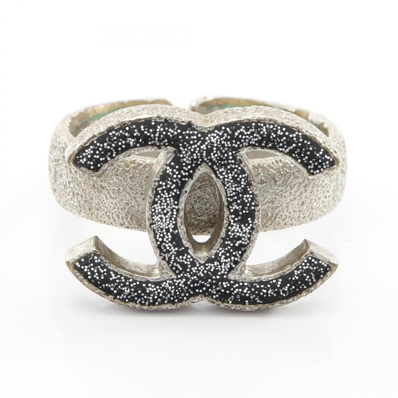 Stainless steel band ring by Chanel: Stainless steel band ring by Chanel Stainless steel band ring by Chanel features a sleek silver design, showcasing the brand's signature style. The used condition reveals some minor signs of wear and 