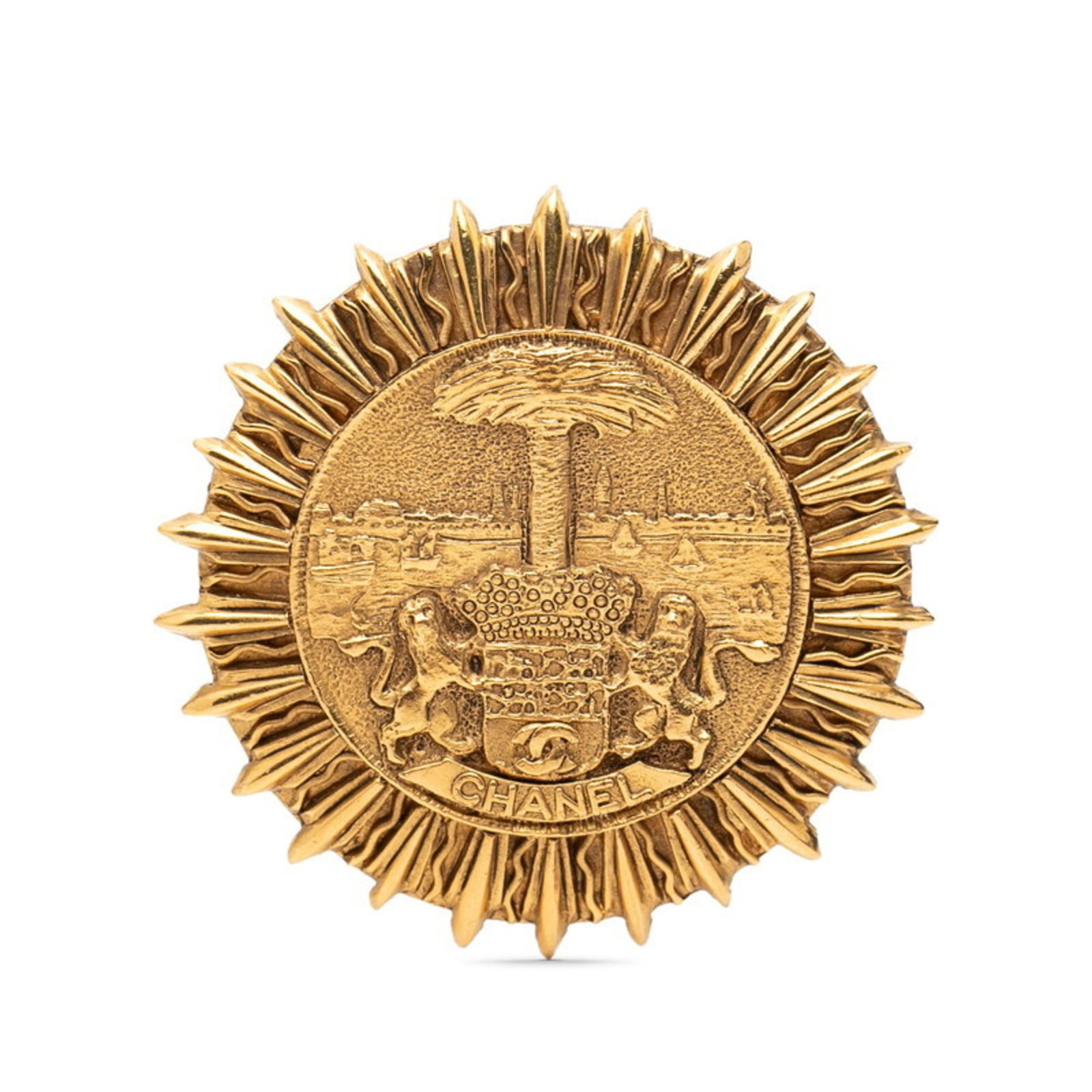 Chanel Brooch: Chanel Brooch This gold Chanel brooch boasts elegant design and subtle wear, with a few traces of usage visible. The intricate details remain well-preserved despite some minor scratches and dirt accum