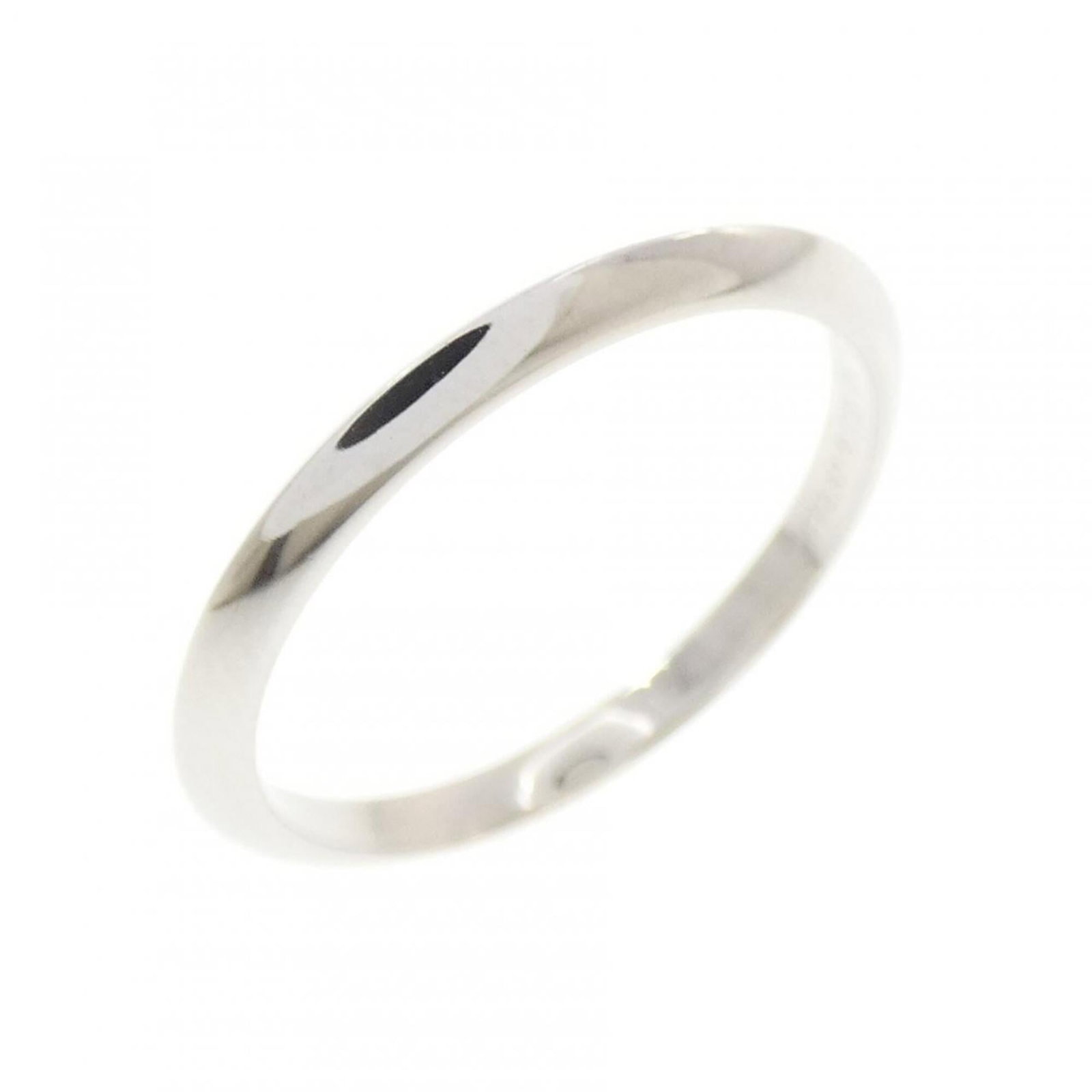 Platinum ring by Tiffany band: Platinum ring by Tiffany band Platinum ring by Tiffany features a band style design made from high-quality platinum. The item shows signs of usage, with a few scratches and dirt visible, but remains