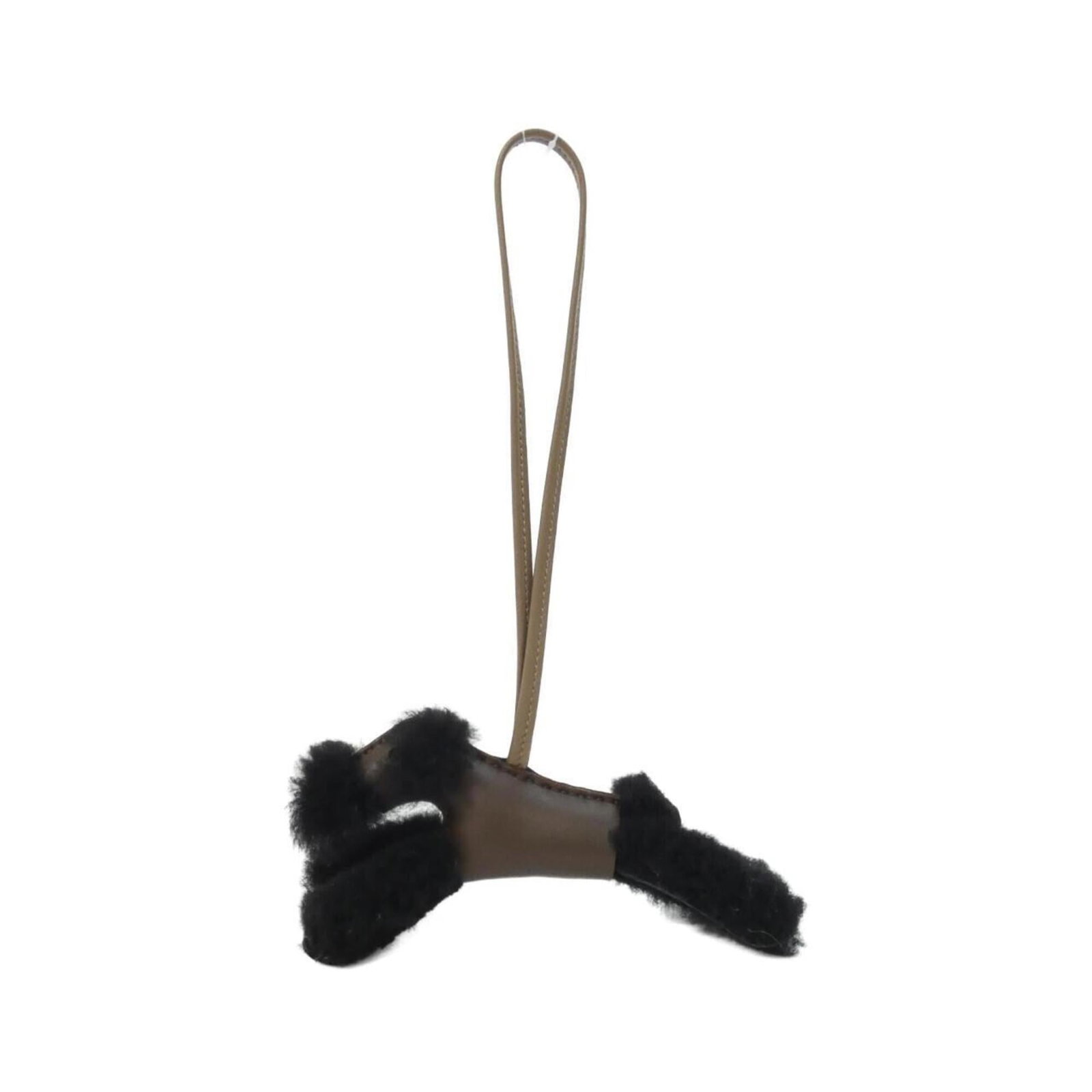 Hermes Handbag Charm Agneau Milo: Hermes Handbag Charm Agneau Milo Agneau Milo charm from Hermes, featuring a sleek black design with subtle nuances in chocolate and etoupe gray hues. This used handbag charm showcases a few traces of