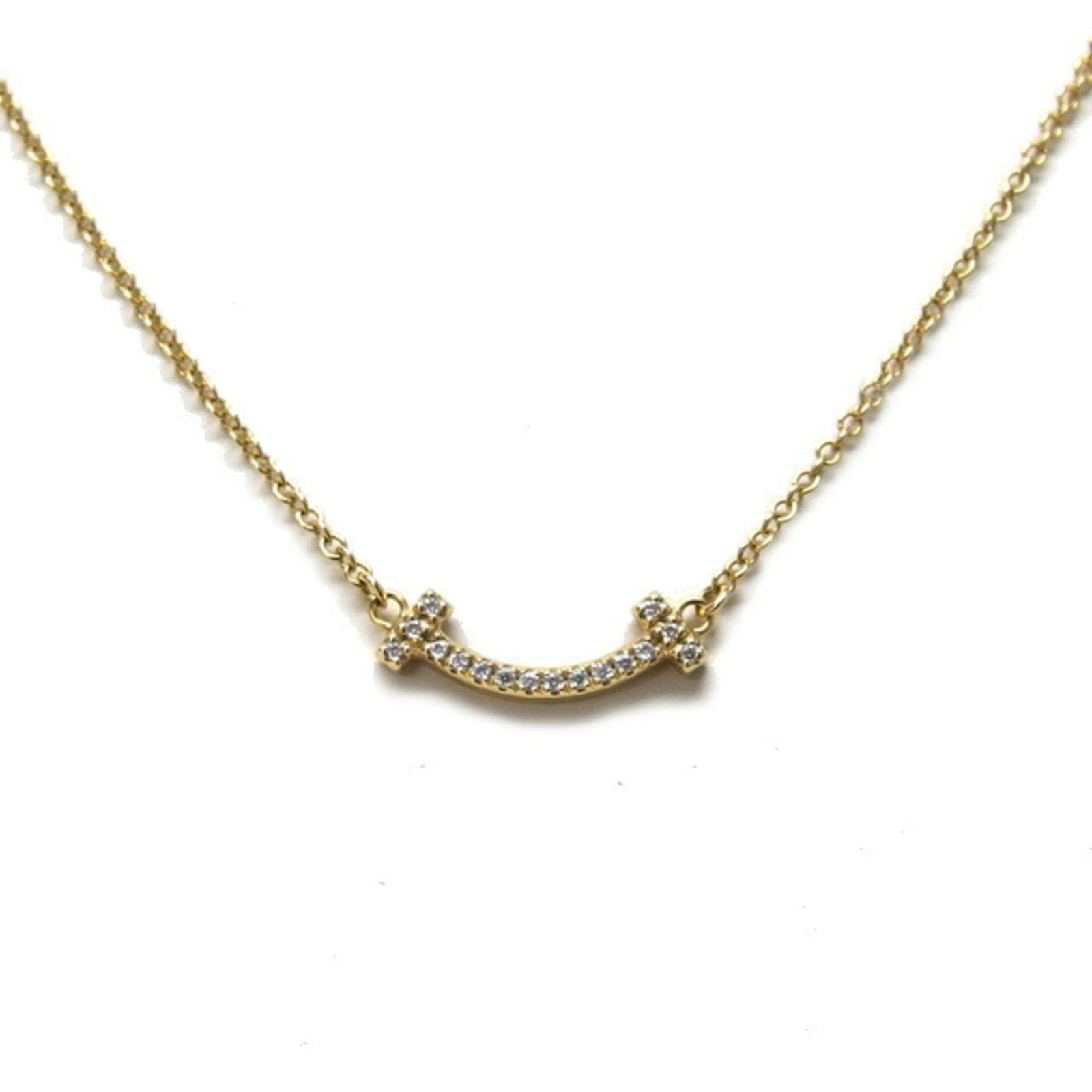 Tiffany & Co. T Smile Pendant Mini Pave Diamonds 18K Yellow Gold: Tiffany & Co. T Smile Pendant Mini Pave Diamonds 18K Yellow Gold Tiffany & Co.'s iconic T Smile Pendant shines in 18K yellow gold, adorned with mini pave diamonds. This petite pendant measures 5mm x