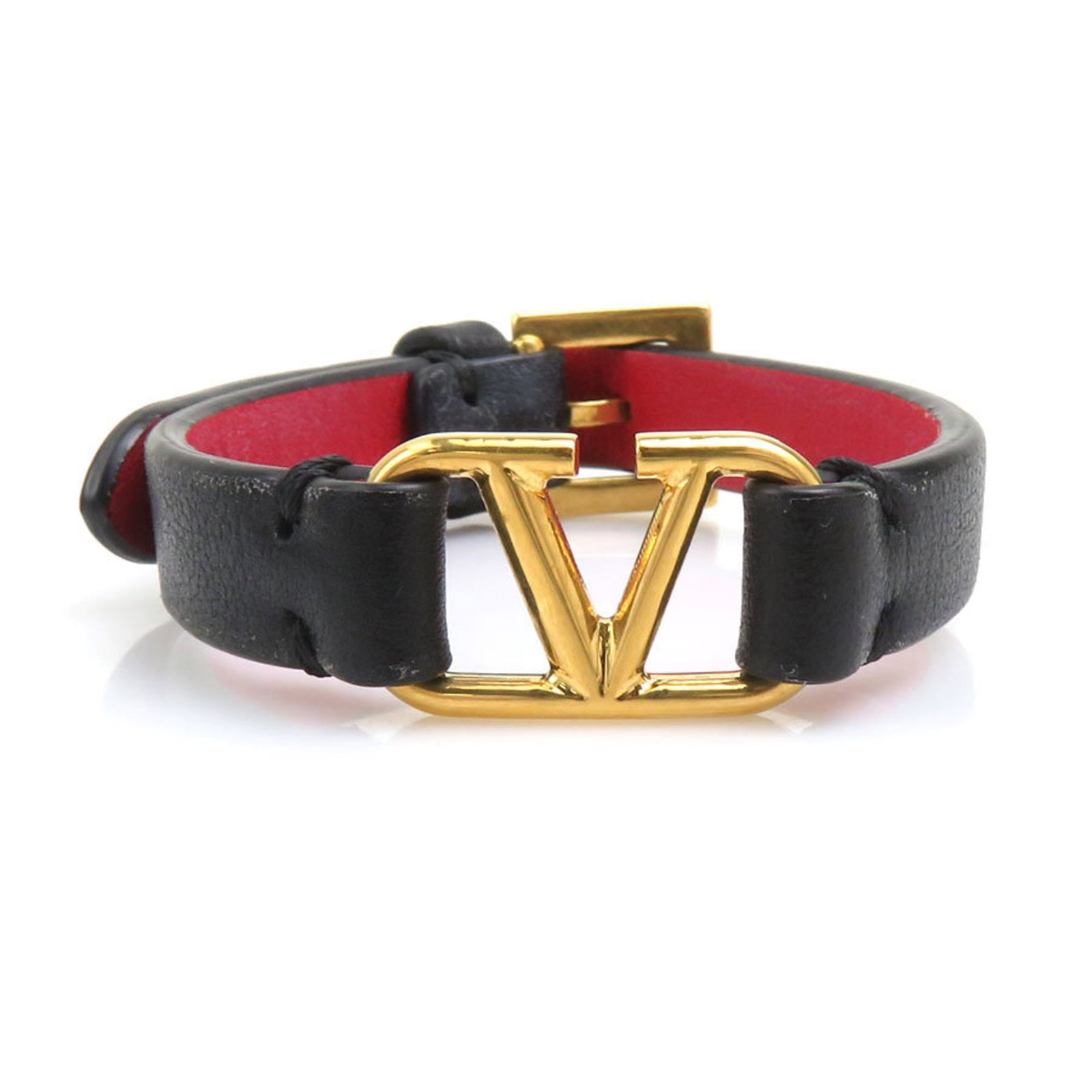 Garavani Charm Leather Valentino: Garavani Charm Leather Valentino Black leather Charm bracelet from Valentino Garavani, featuring a classic design with traces of usage and minor scratches. The bracelet measures between 13.5cm to