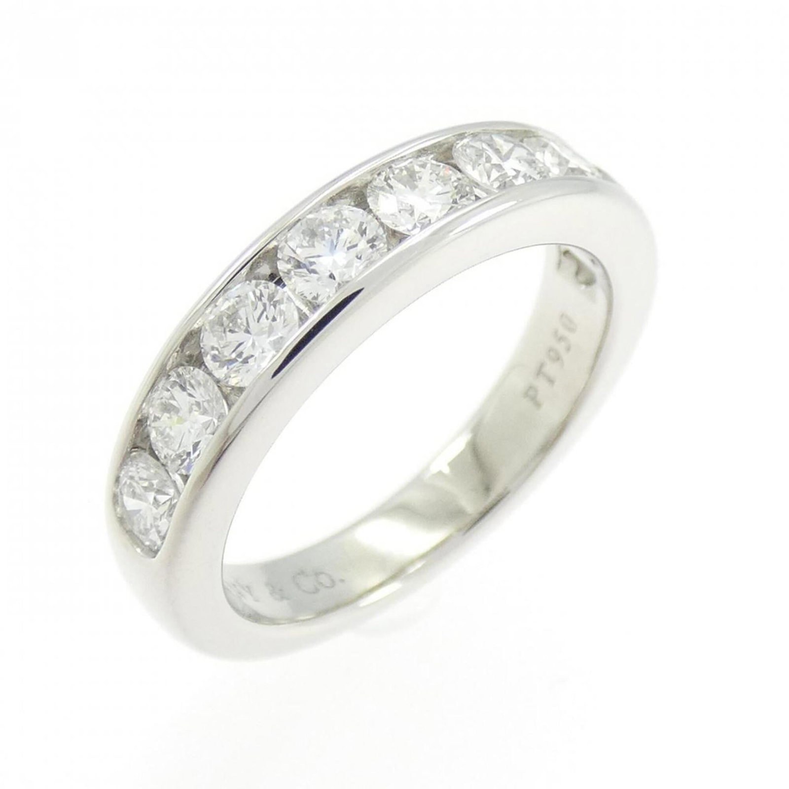 Platinum ring by Tiffany band: Platinum ring by Tiffany band Platinum ring by Tiffany features a diamond stone set in a band design. The item is made from platinum and has a us size of 4, with some minor scratches and dirt visible 