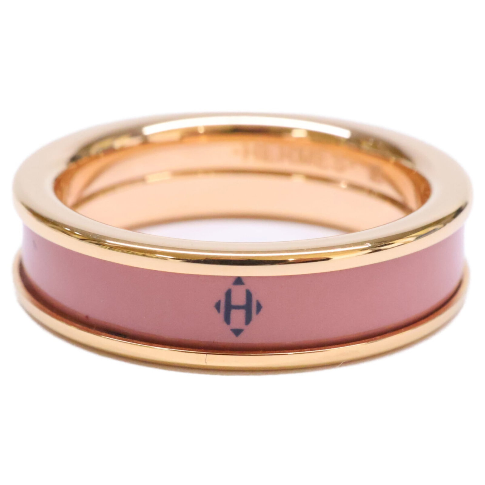 Ring of Metal by Hermes: Ring of Metal by Hermes Rose Gold Band Ring by Hermes features a classic metal design with a subtle touch of elegance. This used ring showcases a few signs of wear, including minor scratches and