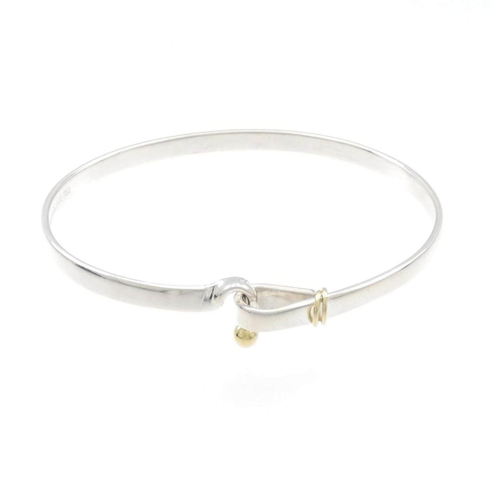 Tiffany Bangle Silver 925 Yellow Gold (18K): Tiffany Bangle Silver 925 Yellow Gold (18K) Silver 925, Yellow Gold (18K) construction gives this Tiffany bangle its distinctive look. The bangle measures 17cm in length and features a few traces of u