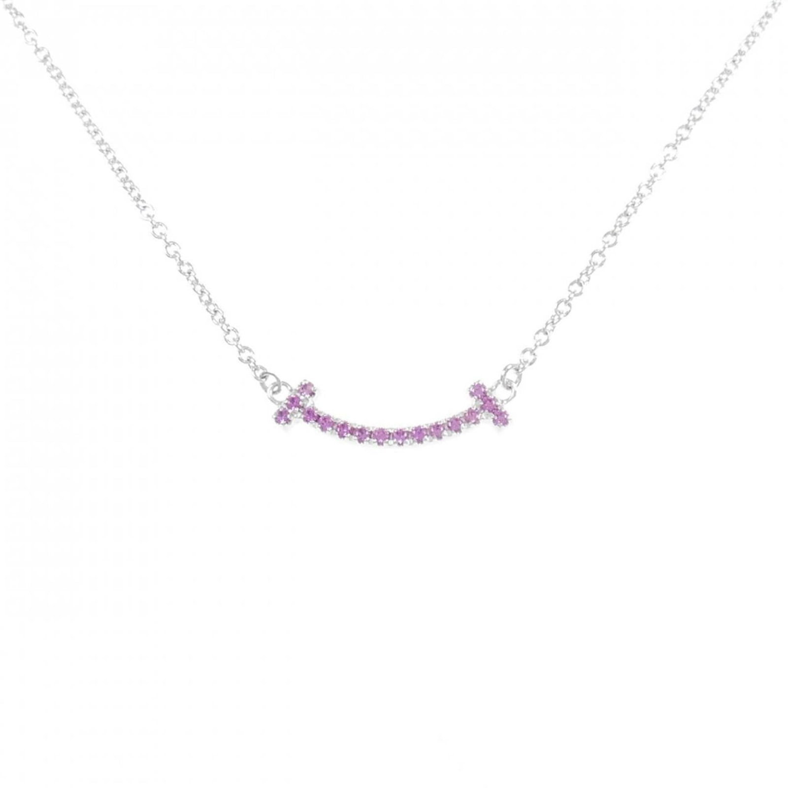Mini Tiffany T Smile Necklace: Mini Tiffany T Smile Necklace White gold (18K) Tiffany necklace features a sapphire pendant, a classic and timeless design. The necklace has a 43 cm - 48 cm circumference and measures 3.7mm x 15.9mm