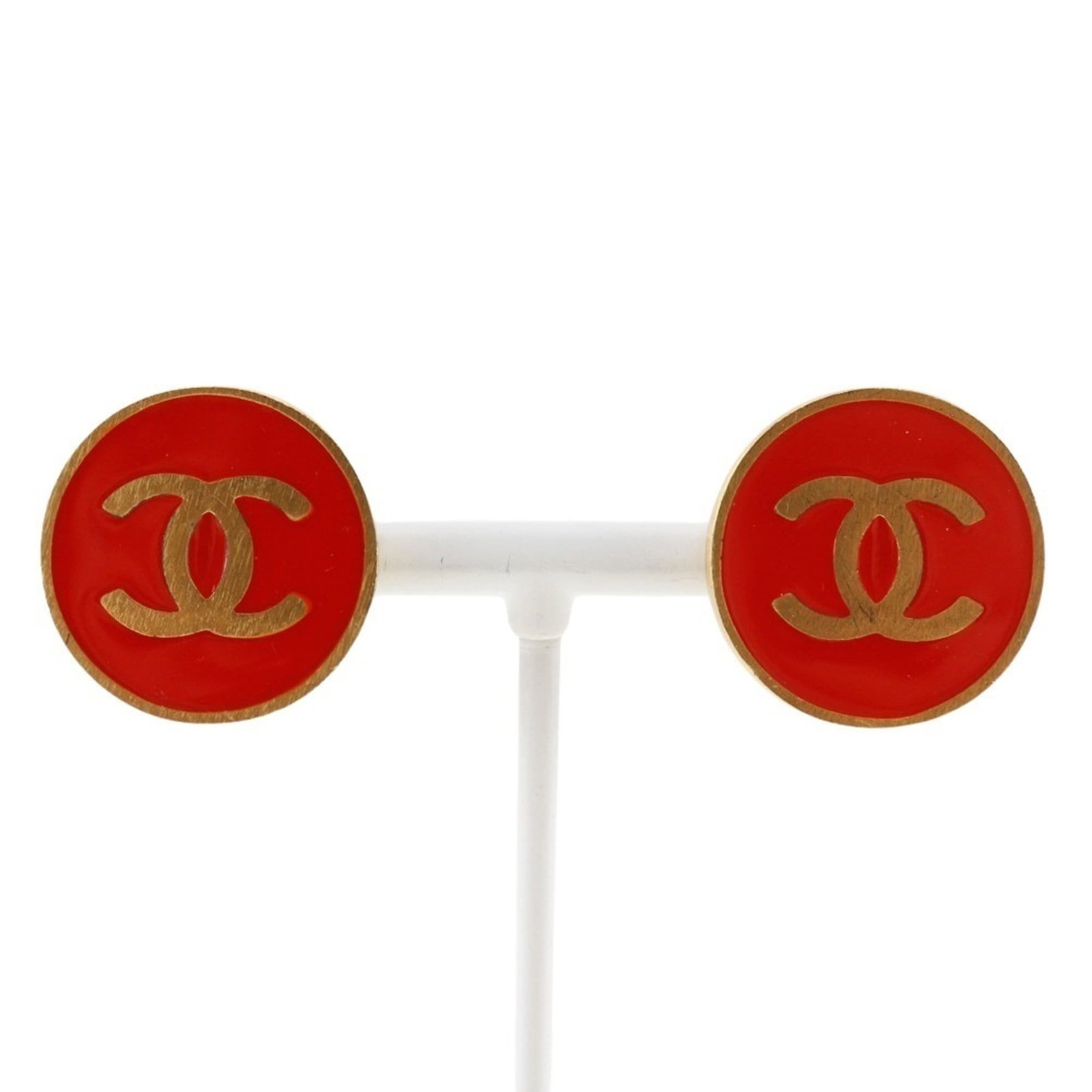 Clip earrings gold plating by Chanel: Clip earrings gold plating by Chanel Clip earrings by Chanel feature gold plating in a striking red color, adding a pop of elegance to any outfit. Made from durable materials, these clip earrings