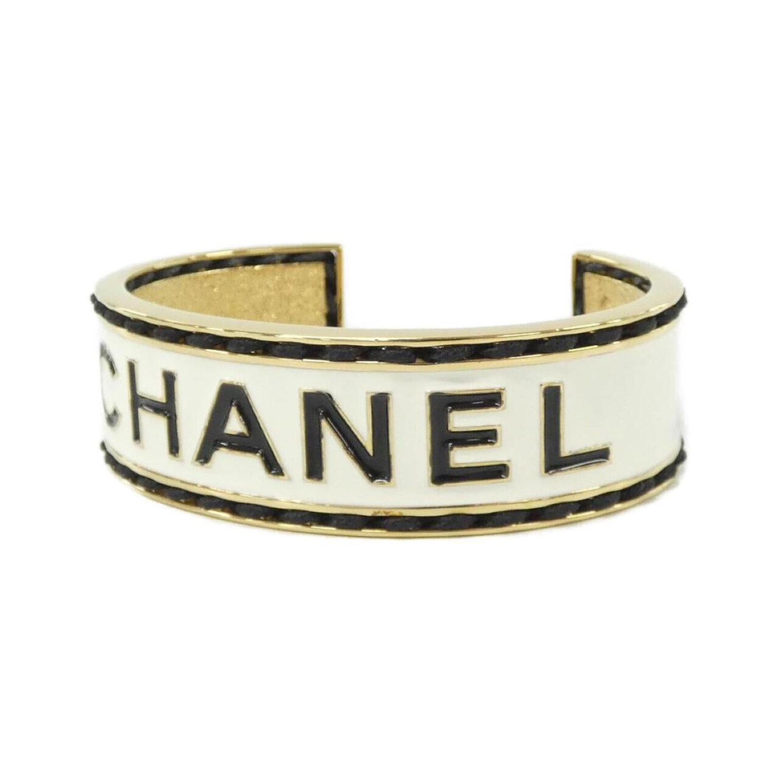 Bangle Chanel: Bangle Chanel Black, Gold, and White Chanel Bangle: A stylish accessory with a few traces of usage, some scratches and dirt visible. The bangle measures 17cm in length and bears a signature from the