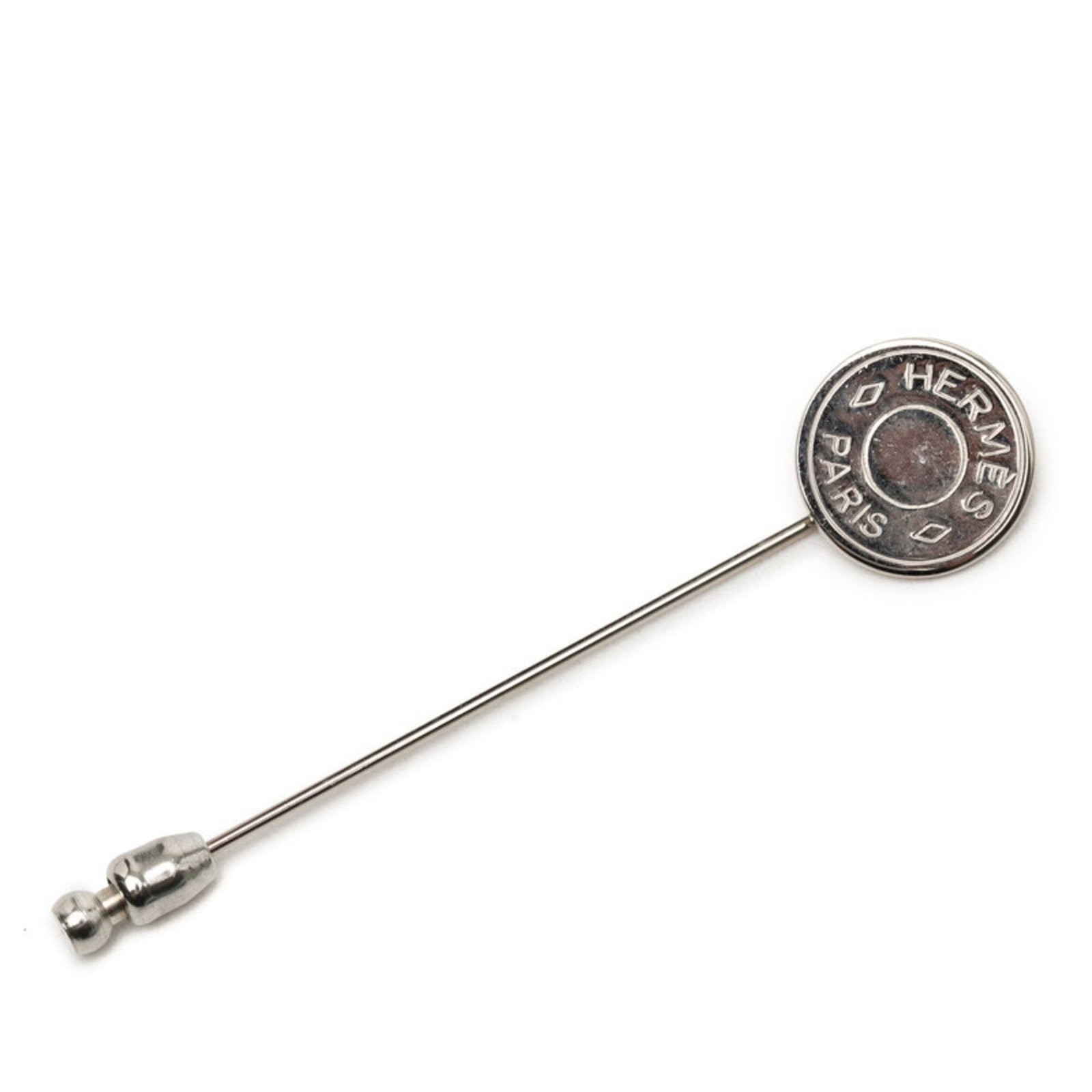 Pin Brooch Hermes Metal: Pin Brooch Hermes Metal Silver Hermes Metal Pin Brooch with Traces of Usage. This used pin brooch features the iconic Hermes brand and has visible scratches and dirt, indicating its age and previous