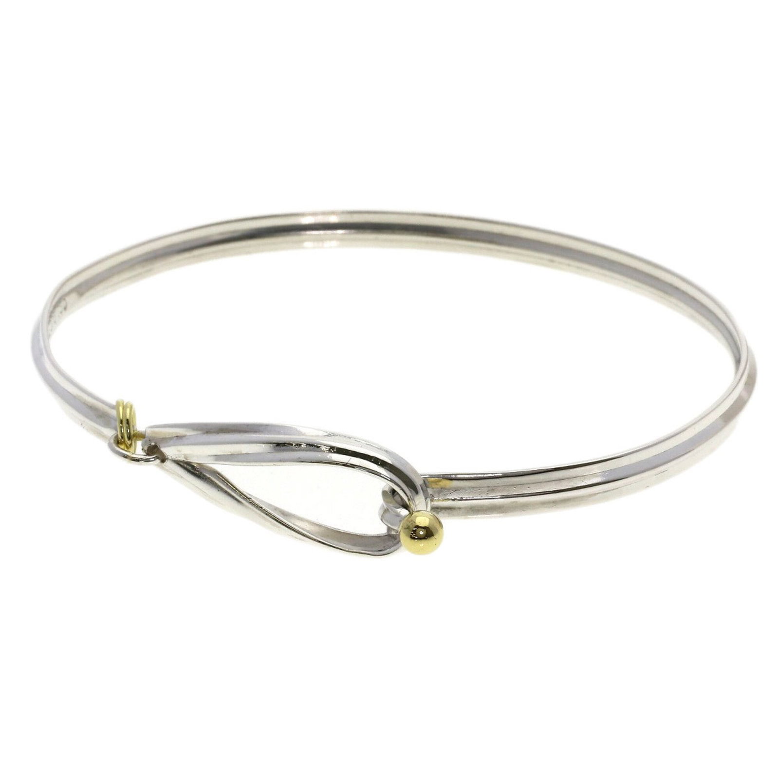 Tiffany Bangle Silver Yellow Gold (18K): Tiffany Bangle Silver Yellow Gold (18K) Silver and yellow gold bangle from Tiffany, crafted with 18K quality. Measuring 7.08 inches in length, this bangle boasts a subtle elegance. In like new conditi