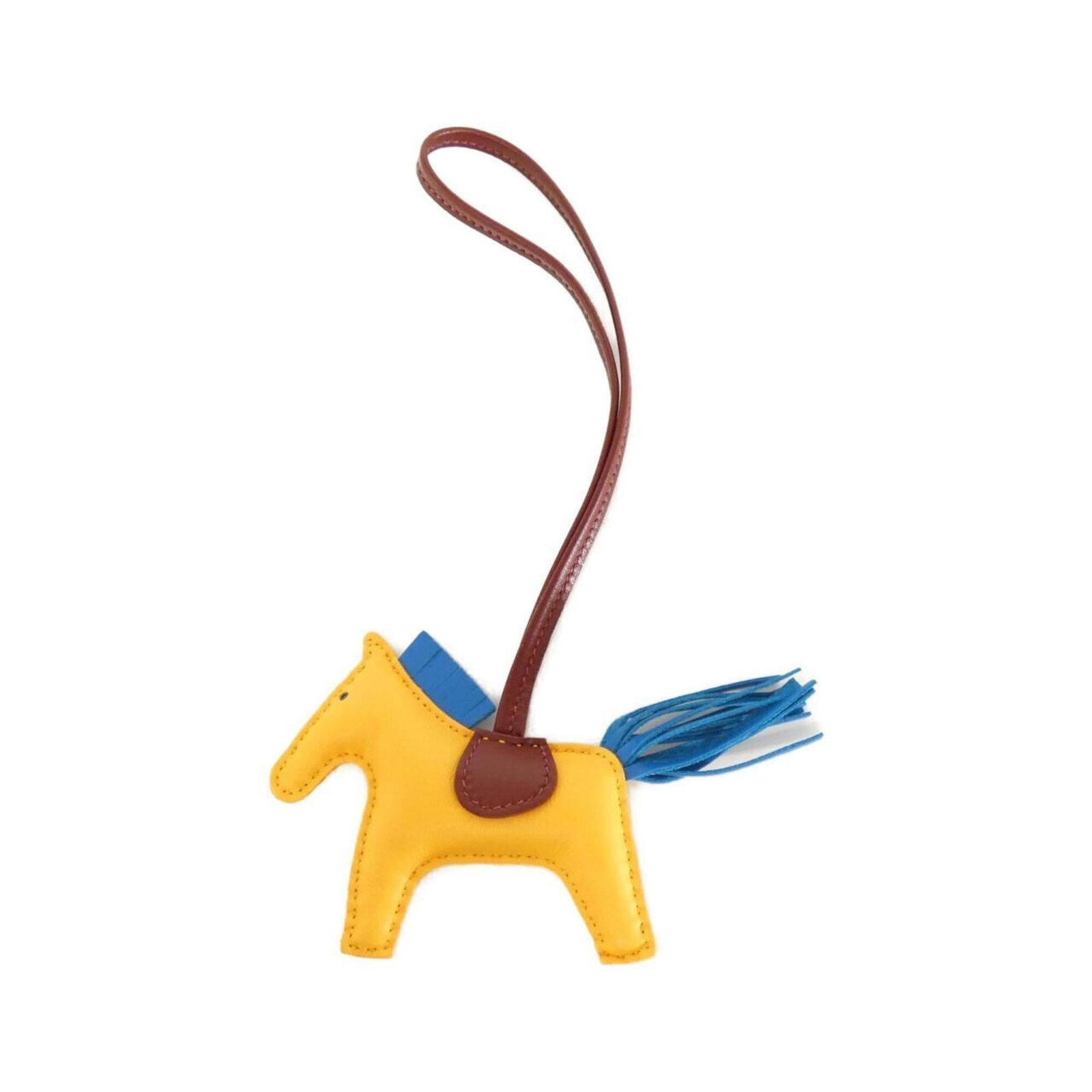 Hermes Handbag Charm Agneau Milo: Hermes Handbag Charm Agneau Milo Agneau Milo, a vibrant blue, Jaune, and Rouge H Stone set into an Hermes Handbag Charm. The Agneau Milo material gives the charm its distinctive look, while the H