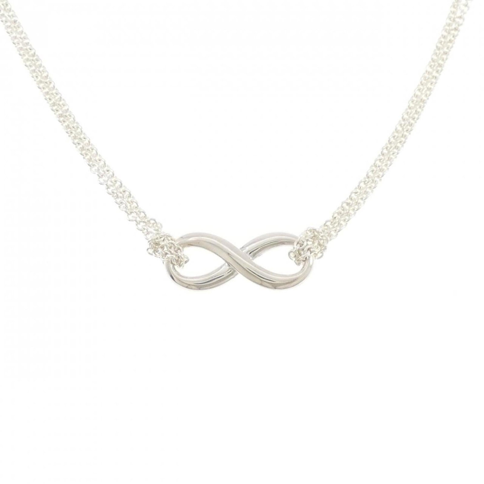 Infinity Necklace by Tiffany: Infinity Necklace by Tiffany Silver 925 Infinity Necklace by Tiffany, with a 41 cm / 16.14'' adjustable neck circumference and an 8mm x 20.1mm pendant bearing the brand's signature. This used (like