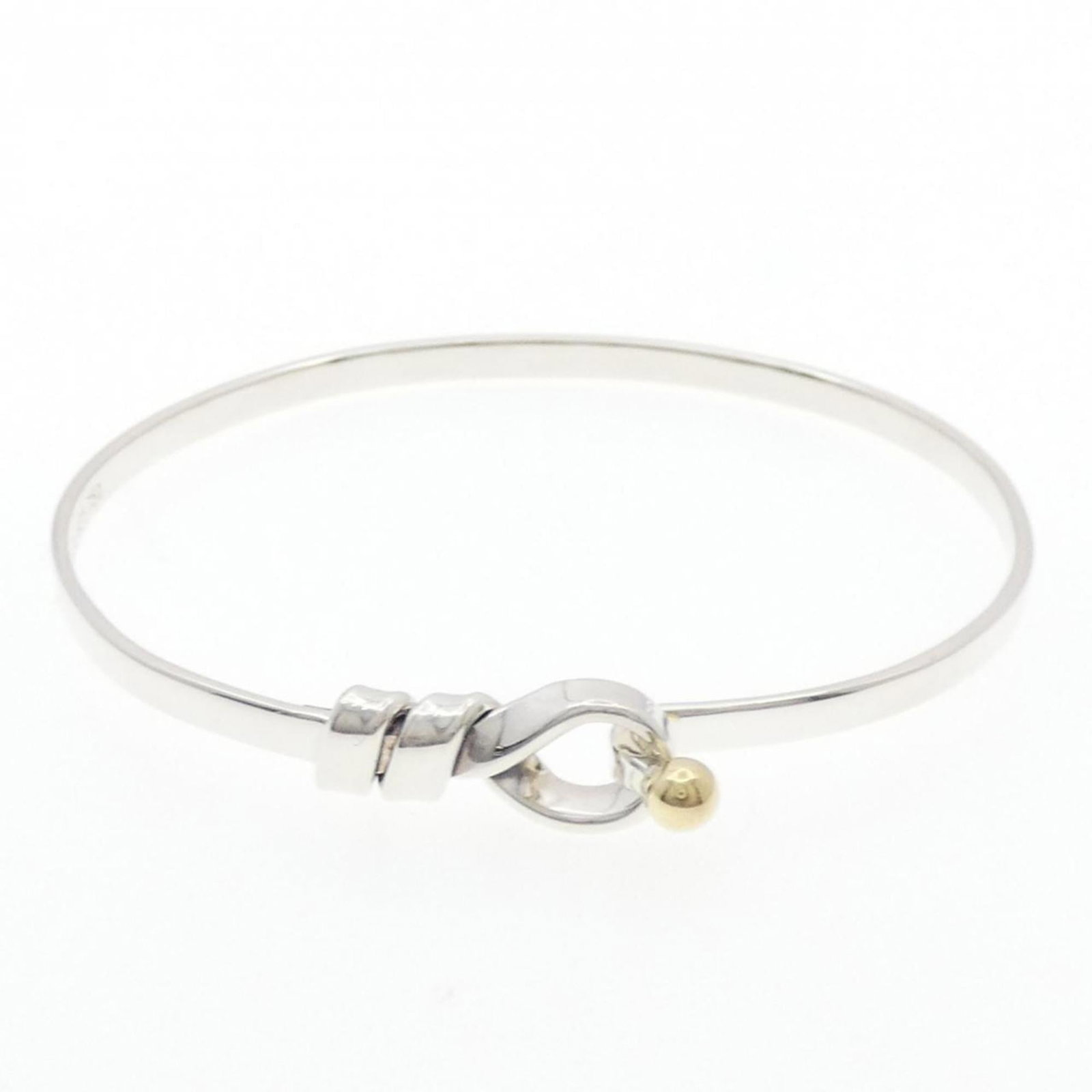 Tiffany Bangle Silver 925 Yellow Gold (18K): Tiffany Bangle Silver 925 Yellow Gold (18K) Silver and yellow gold combine in this elegant Tiffany bangle, crafted from high-quality 925 silver with an 18K yellow gold accent. The 17cm length makes