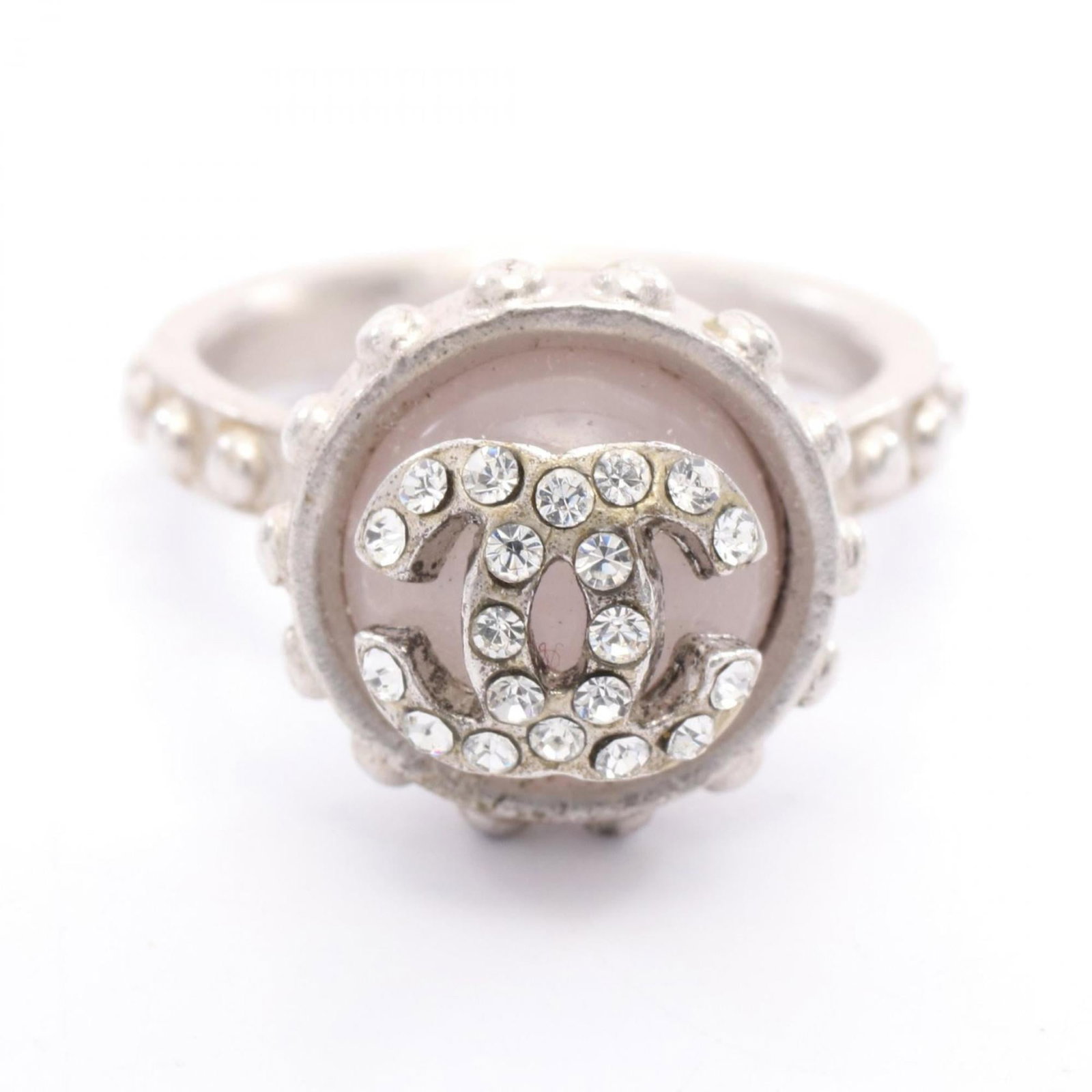 Rhinestone stainless steel band ring Chanel: Rhinestone stainless steel band ring Chanel Stainless steel band ring with rhinestone details, reminiscent of the iconic designs from Chanel. The clear and pink hues add a touch of elegance to this