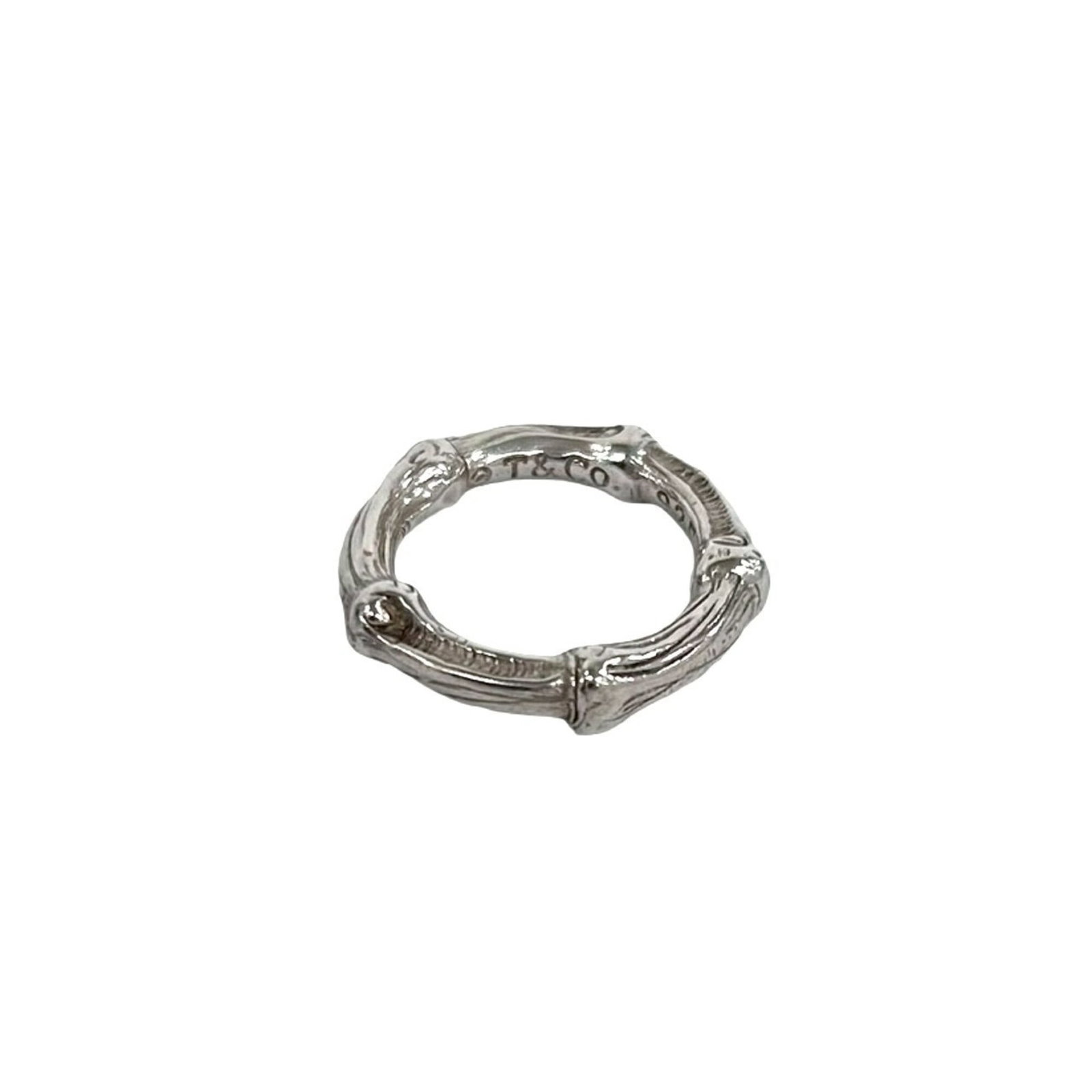 Tiffany Band Ring Silver 925: Tiffany Band Ring Silver 925 Silver band ring from Tiffany, made from sterling silver (925). The ring bears the signature of its creator and has been used, with some signs of wear visible. Overall, it