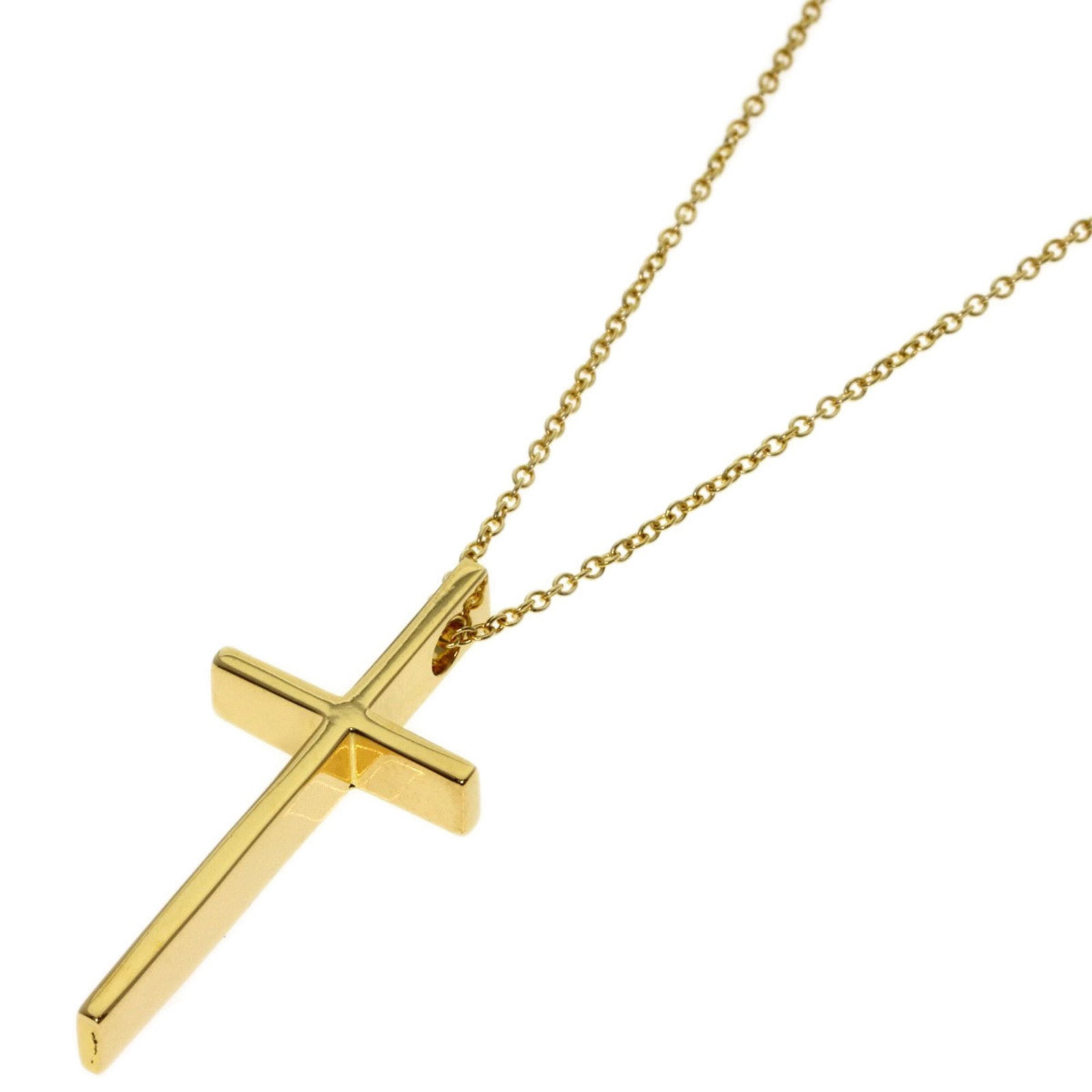 Women's 18K yellow gold cross necklace from Tiffany & Co.: Women's 18K yellow gold cross necklace from Tiffany & Co. 18K yellow gold cross necklace from Tiffany & Co. in excellent condition, with some minor traces of usage and scratches visible. The necklace 