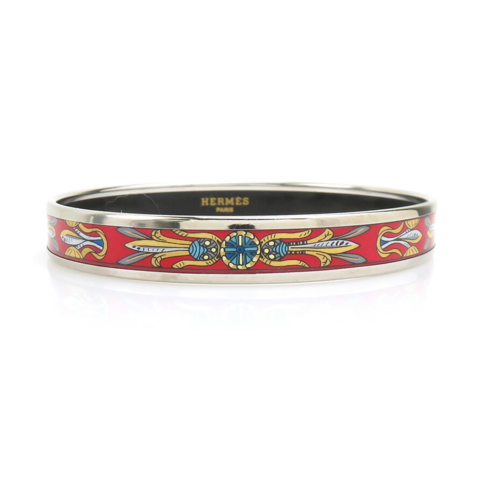 Metal enamel bangle by Hermes: Metal enamel bangle by Hermes Metal enamel bangle by Hermes, featuring multi-color and red accents on a silver base, measures 21cm in length. The bangle bears traces of usage with minor scratches and