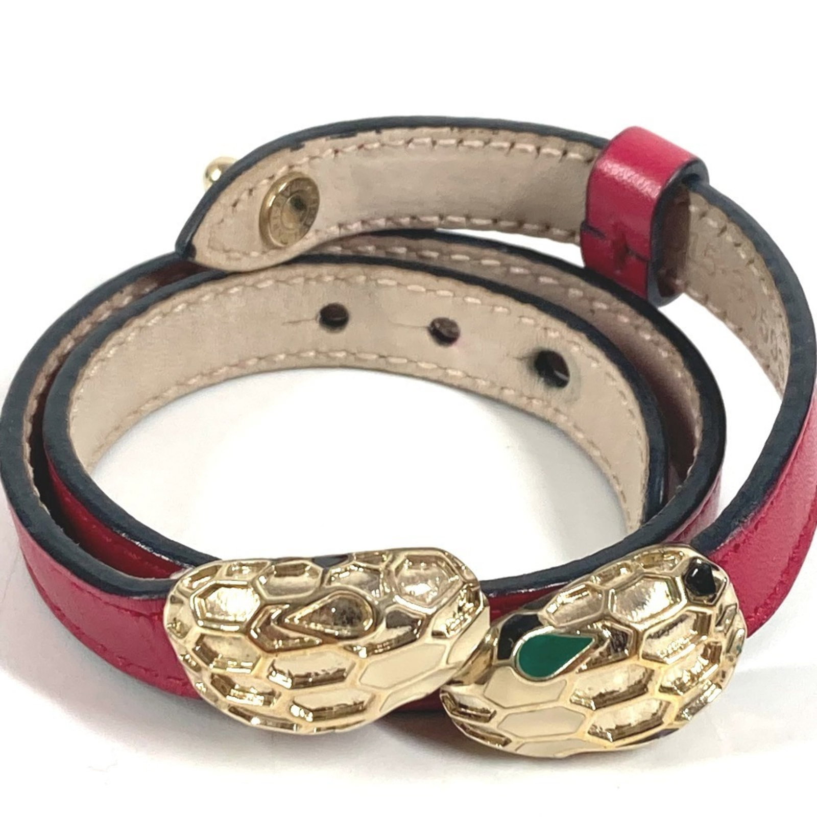 Leather Bvlgari Charm Bracelet: Leather Bvlgari Charm Bracelet Gold and pink leather Bvlgari charm bracelet, measuring 38cm in length. The bracelet features traces of usage with scratches and dirt, but remains generally in good cond