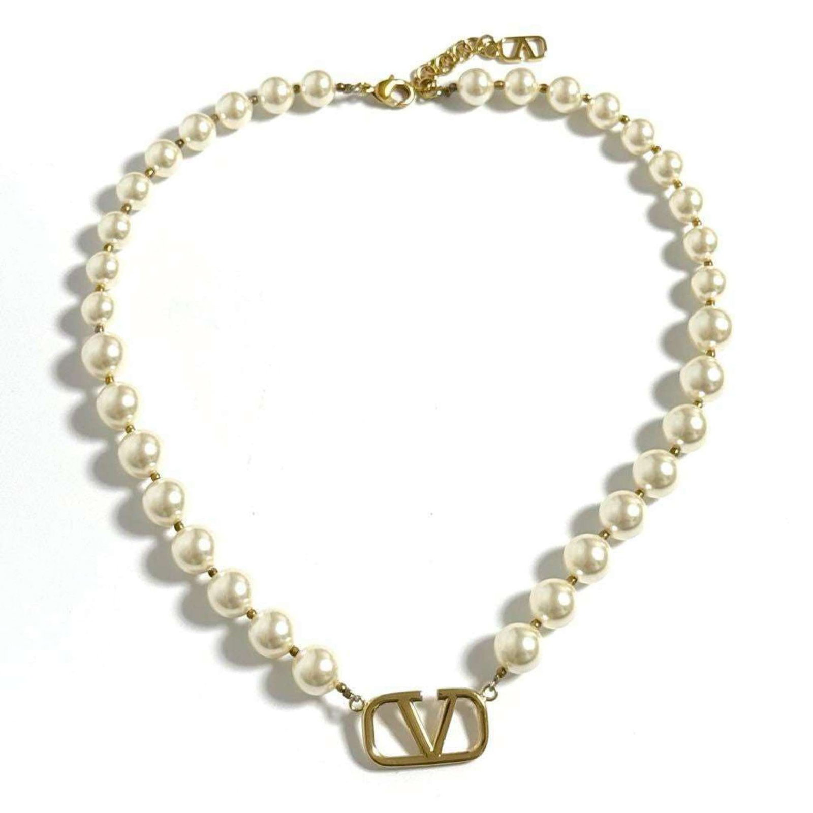 Valentino Women's Pearl Logo Bead Necklace: Valentino Women's Pearl Logo Bead Necklace Valentino's Pearl Logo Bead Necklace boasts a timeless design with artificial pearls and metal accents, adding a touch of elegance to any outfit. With a