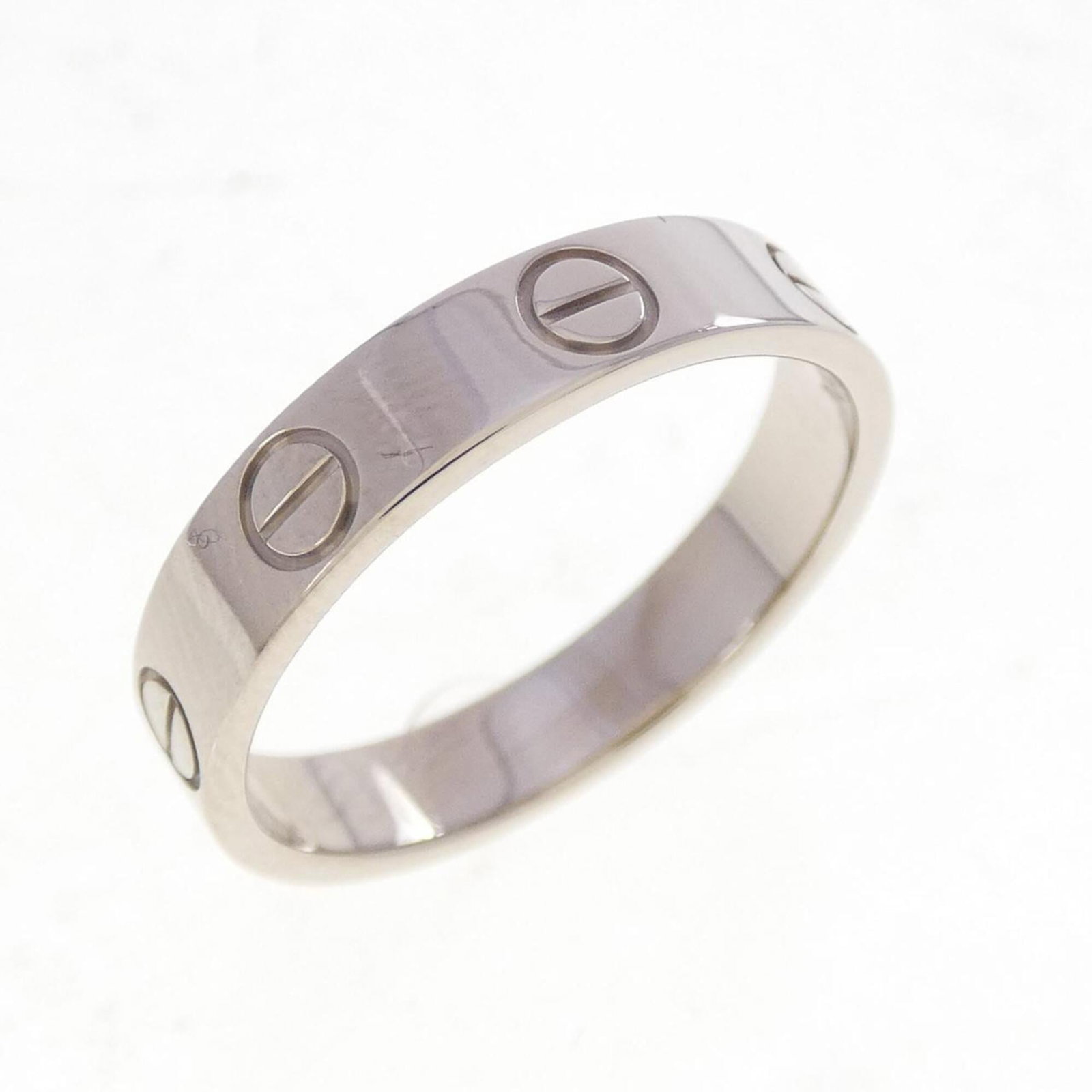 Love Ring from Cartier: Love Ring from Cartier Cartier's signature white gold setting adds an air of sophistication to this elegant love ring, featuring a few subtle scratches and minor dirt accumulation that add to its worn