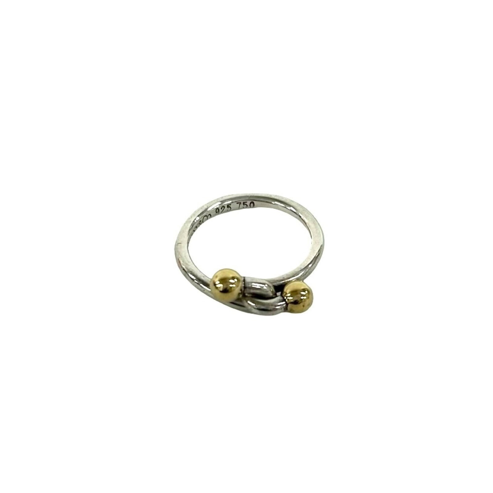 Tiffany Band Ring Silver 925 Yellow Gold (18K): Tiffany Band Ring Silver 925 Yellow Gold (18K) Silver 925, Yellow Gold (18K) construction adds durability and shine to this Tiffany band ring. The item bears traces of usage with scratches / dirt visi