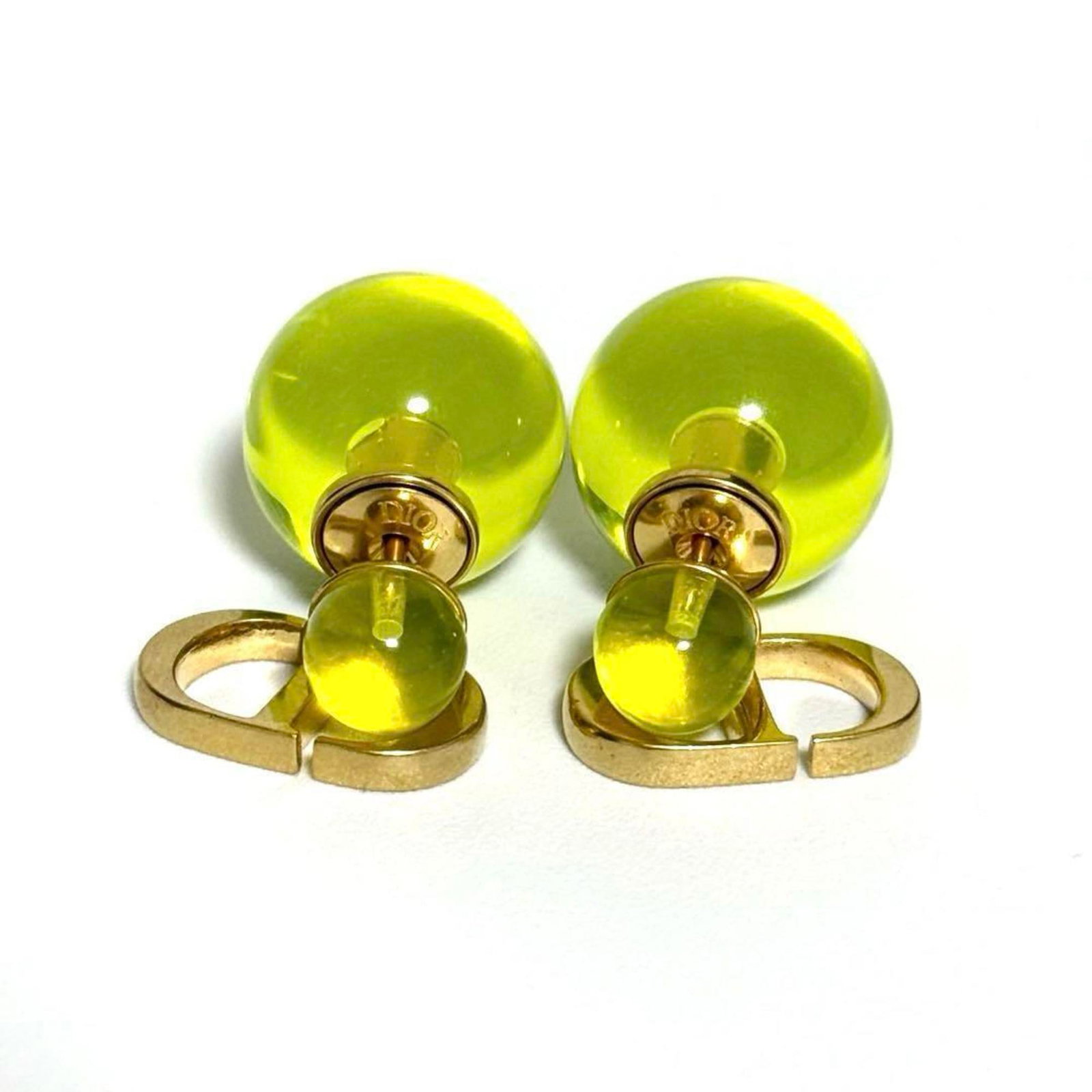 Metal Plastic Christian Dior Stud Earrings: Metal Plastic Christian Dior Stud Earrings Metal Plastic Christian Dior Stud Earrings are made from metal and plastic, bearing the iconic Christian Dior brand. In mint condition, these stud earrings s